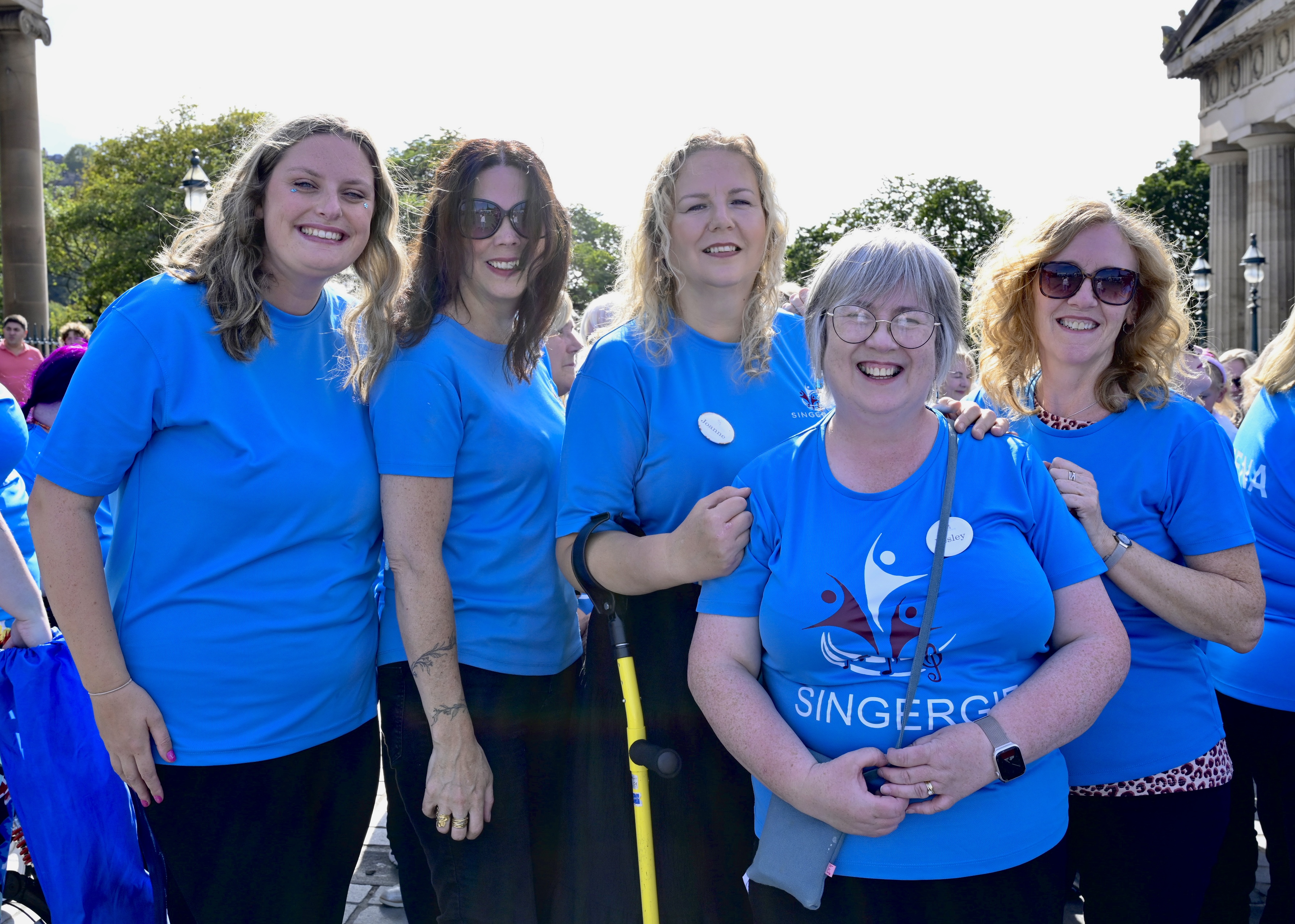 A small group of choir members chatting during a rehearsal break
