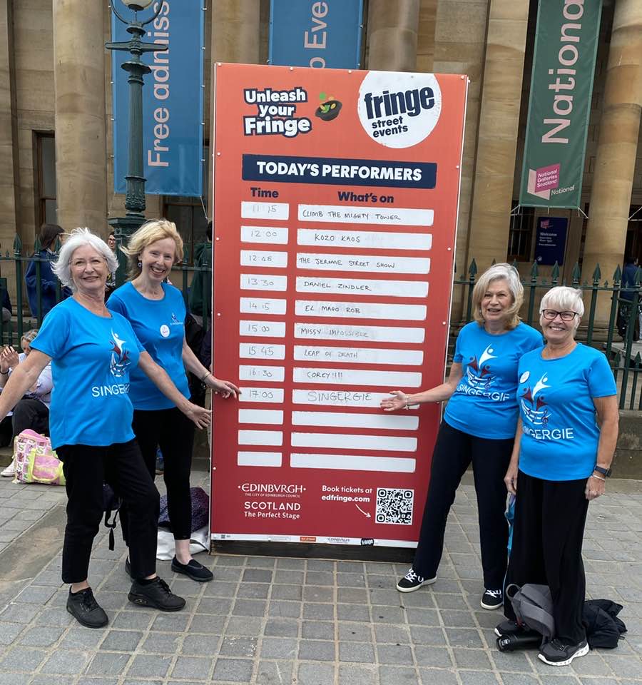 Choir members taking a bow as the audience applauds