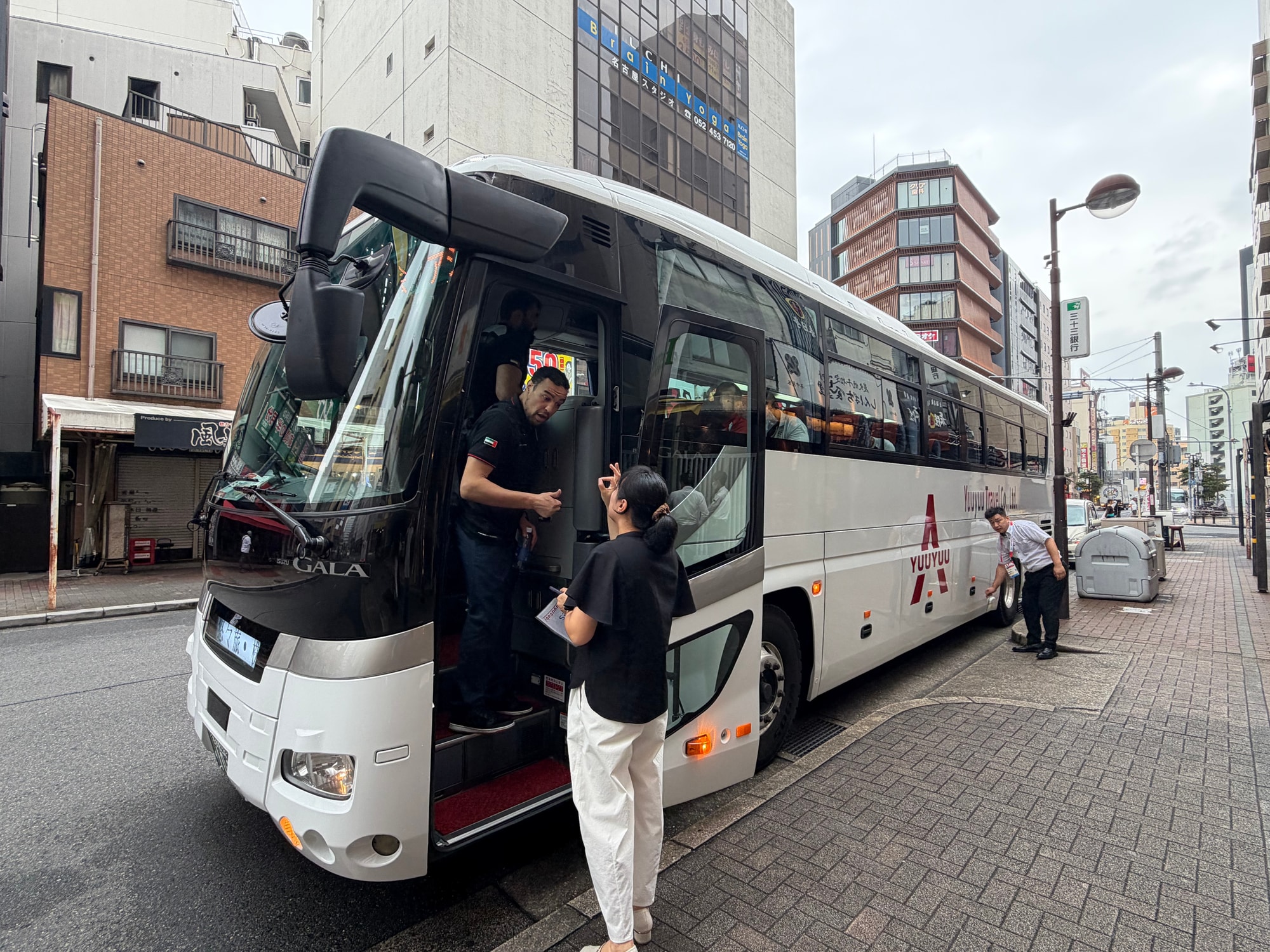 悠々旅のバスのそばでお客様とやり取りする様子。 悠々旅のバスのそばでお客様とやり取りする様子。