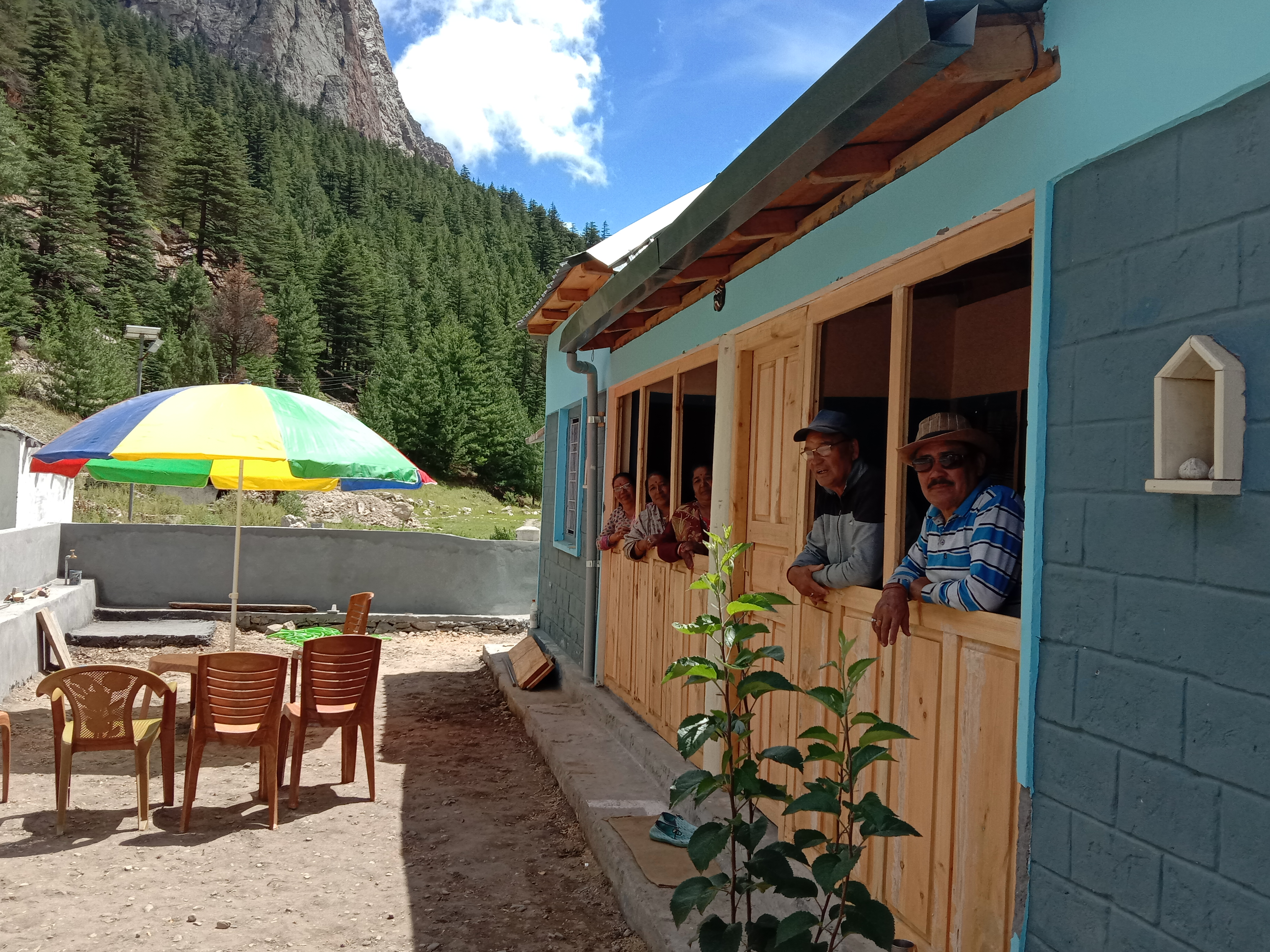 Panoramic view of Dhauli Ganga Homestay with mountains