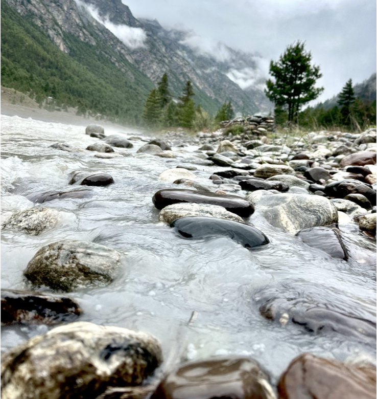 Person relaxing by Dhauli Ganga river