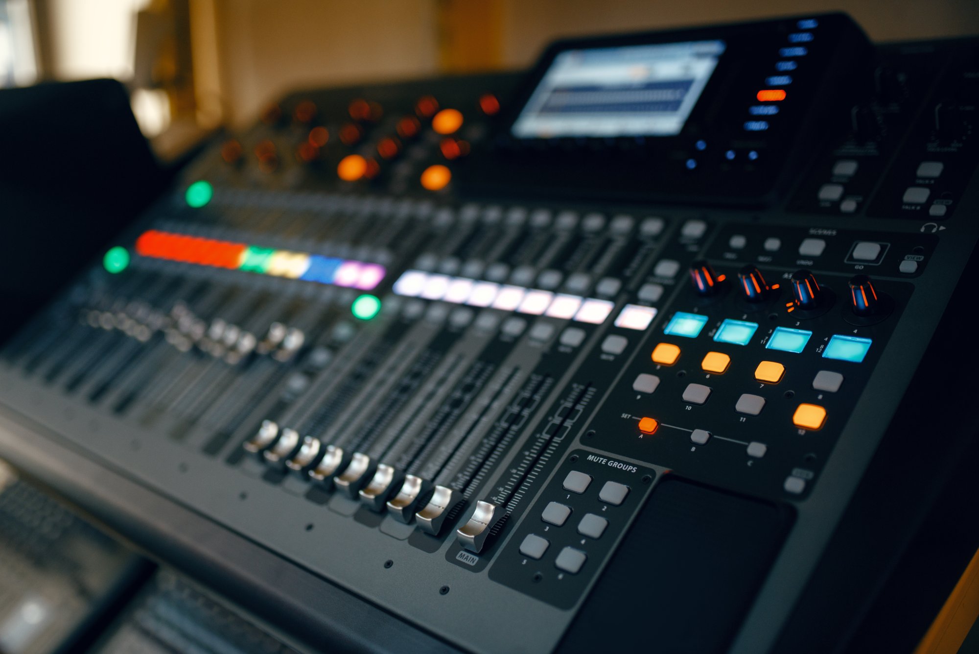Digital audio mixing console faders and routing controls for church livestream sound setup.