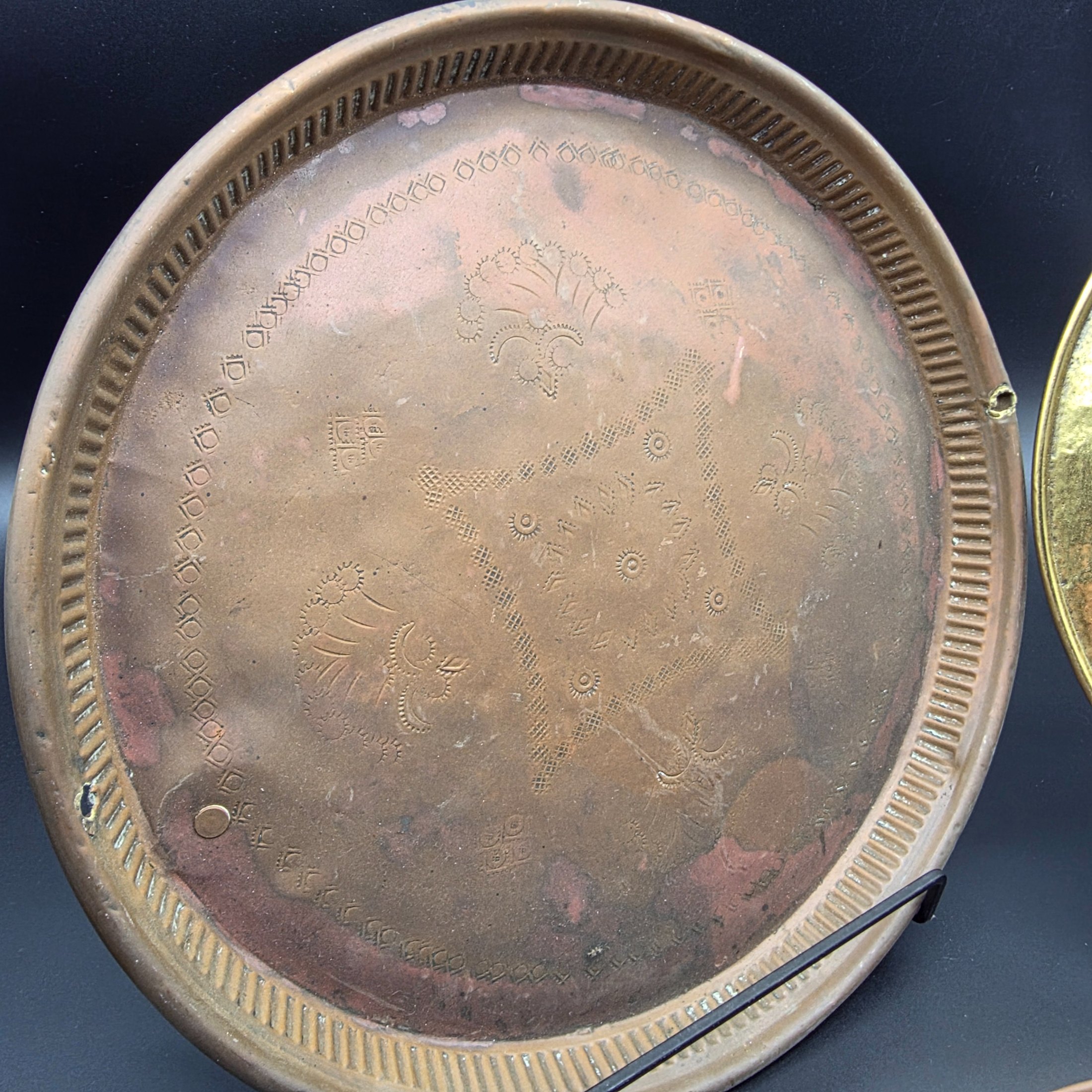 A collection of vintage copper and brass decorative and functional items, comprising two copper trays, a copper teapot, and an embossed brass wall plate depicting a sailing ship. - View 2