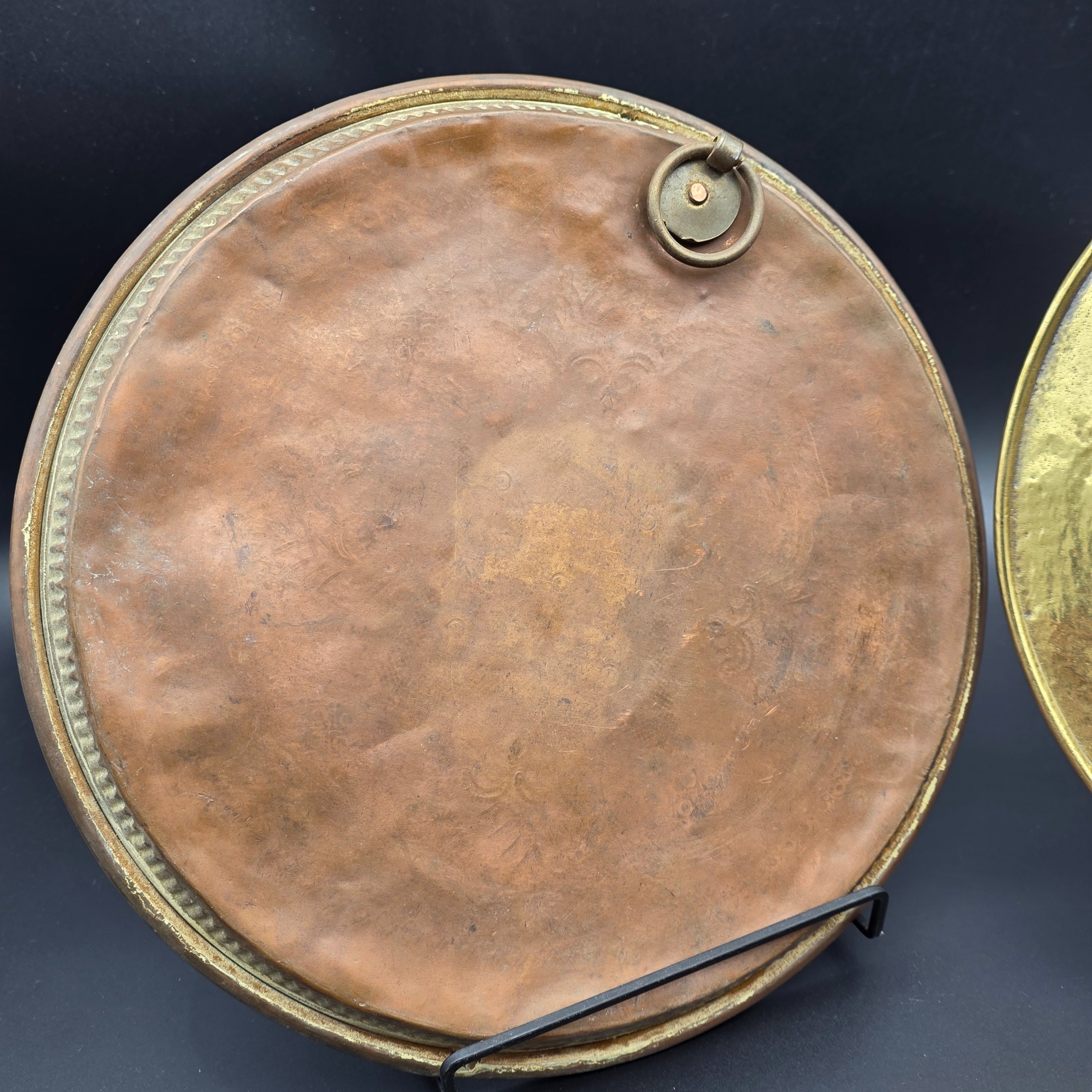 A collection of vintage copper and brass decorative and functional items, comprising two copper trays, a copper teapot, and an embossed brass wall plate depicting a sailing ship. - View 7