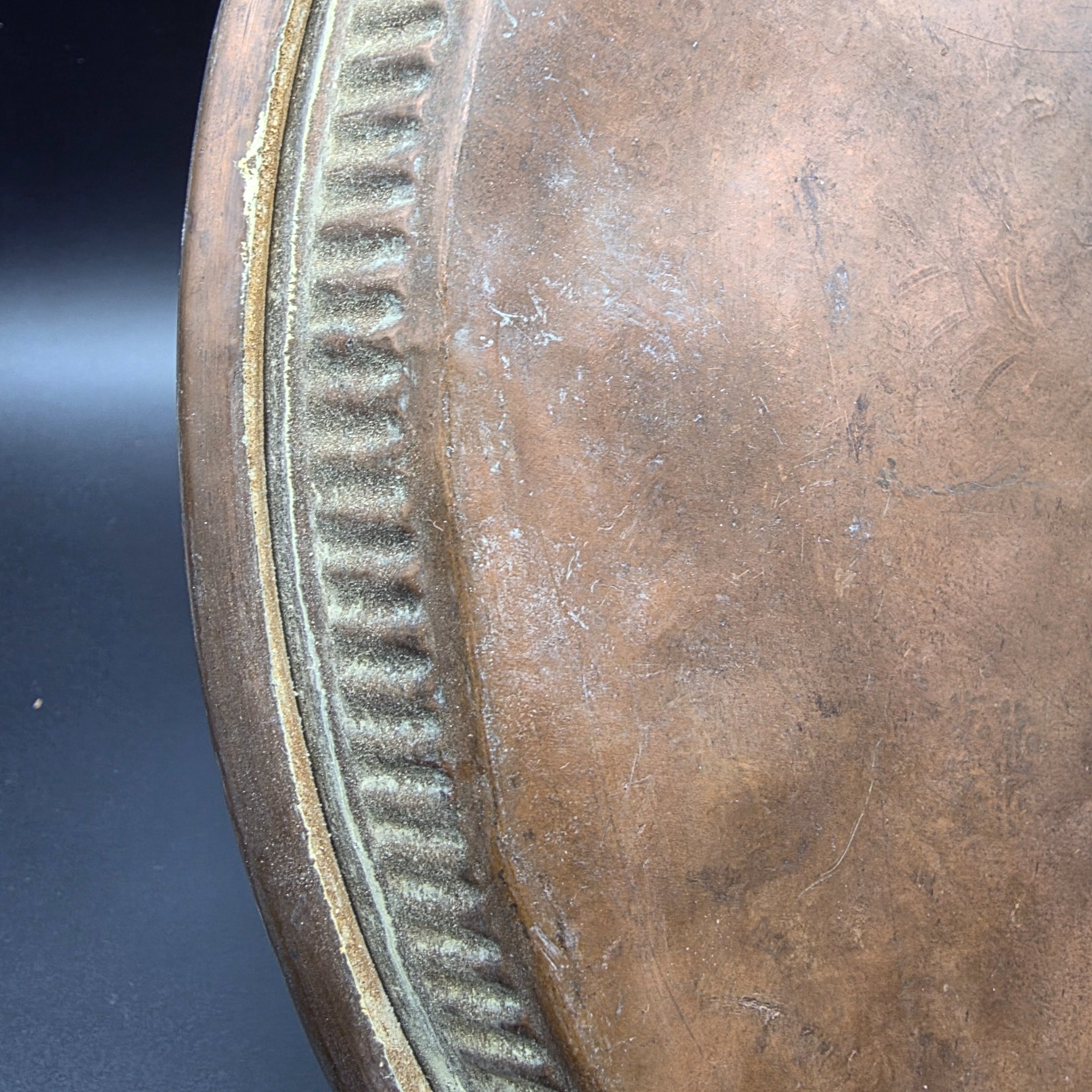 A collection of vintage copper and brass decorative and functional items, comprising two copper trays, a copper teapot, and an embossed brass wall plate depicting a sailing ship. - View 8