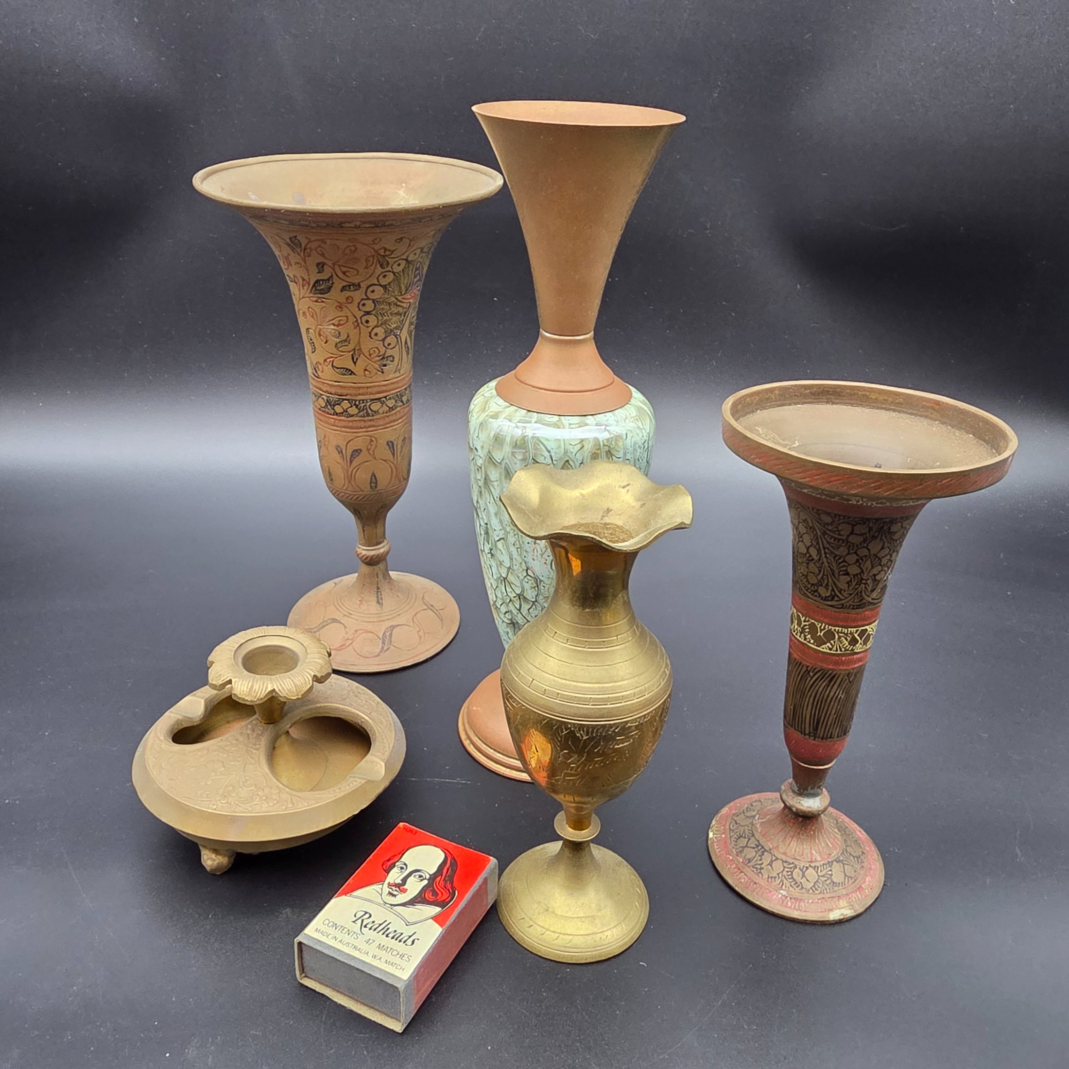 A curated collection of vintage decorative brass items, likely from the mid-20th century, featuring various engraved, enameled, and glazed finishes. - View 2