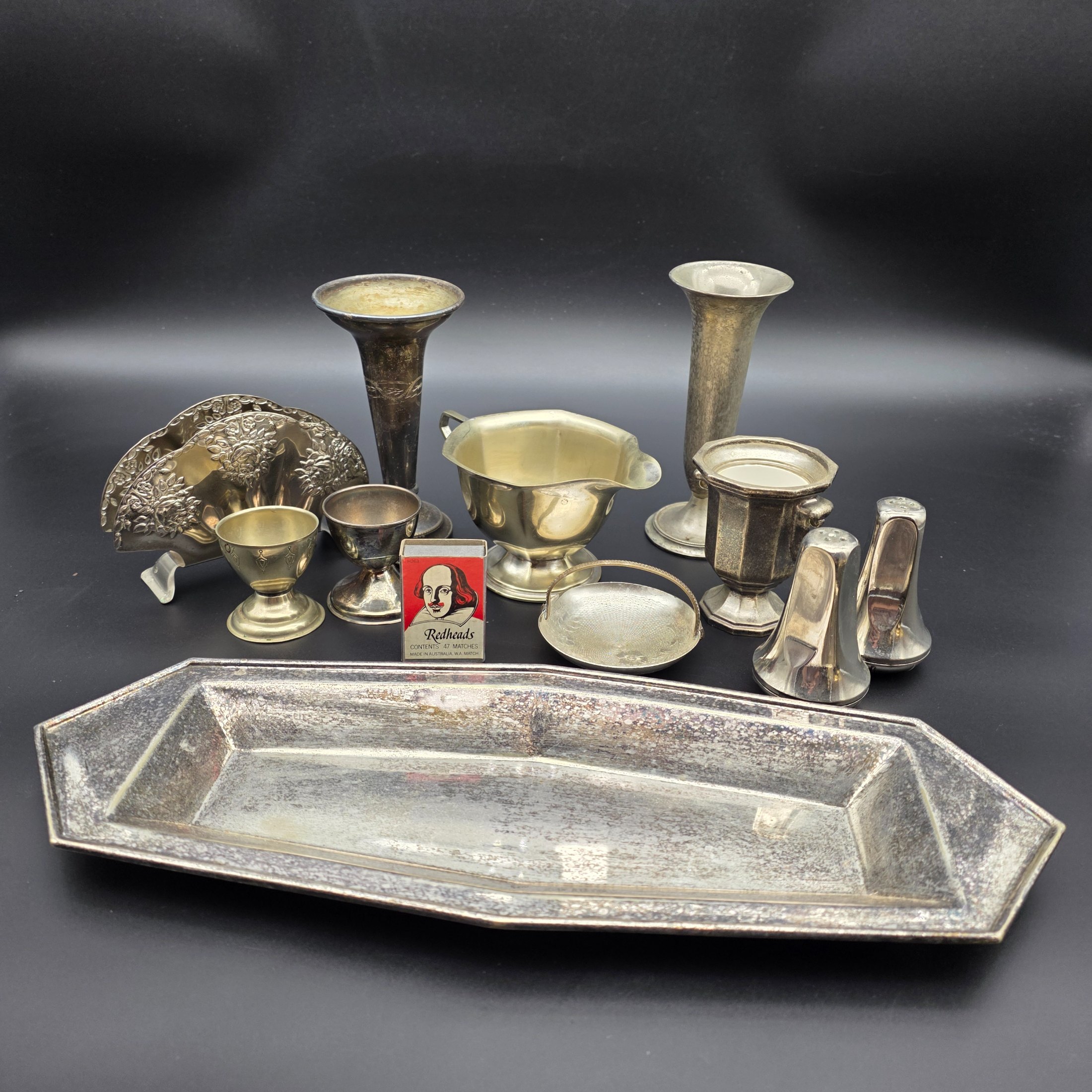 A diverse collection of vintage English silver-plated homewares, featuring various decorative and functional pieces.