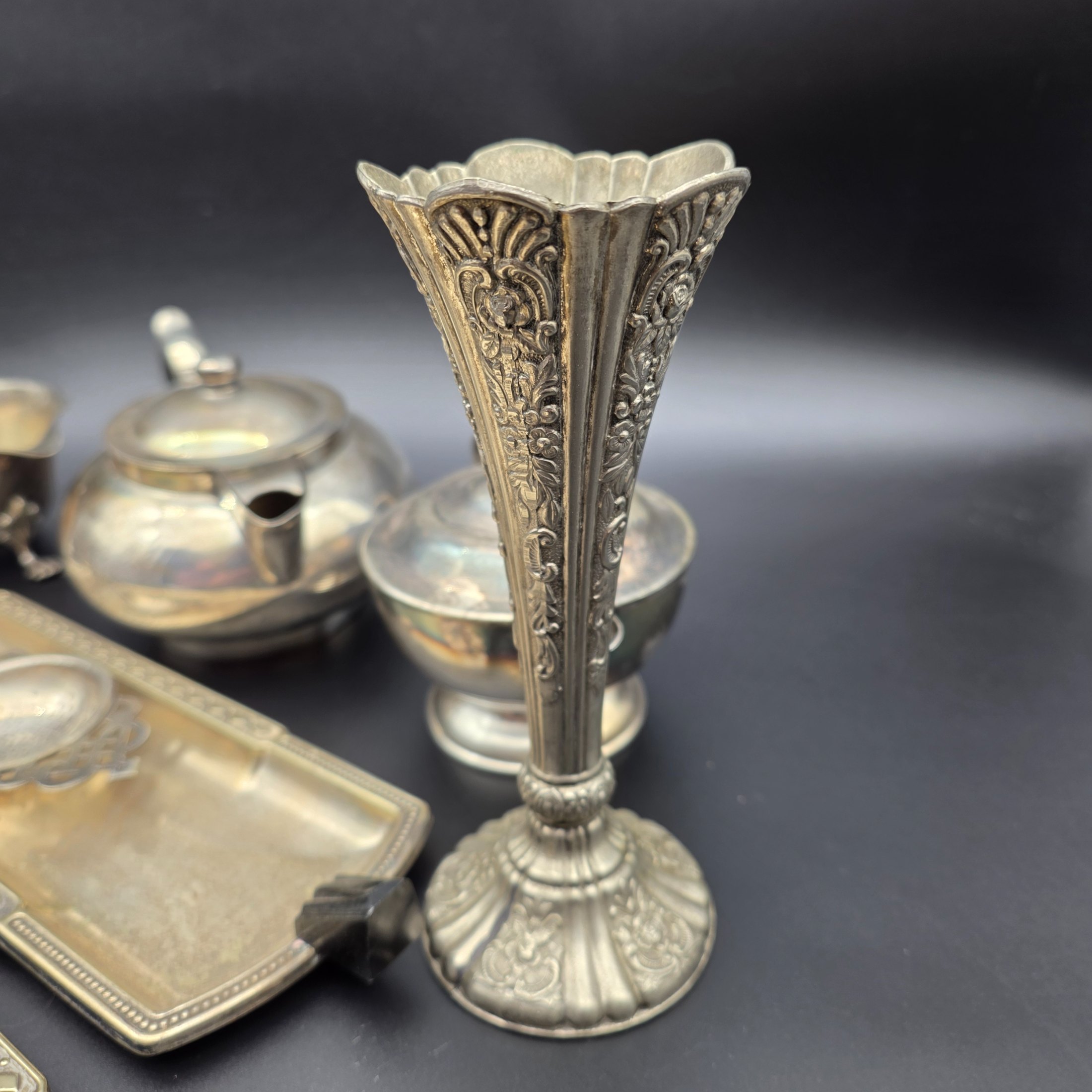 A varied collection of vintage F.B. Rogers silverplate items, including a compote, teapot, cream jug, sugar bowl, vase, goblet, and various trays, all showing signs of age and tarnishing. - View 2