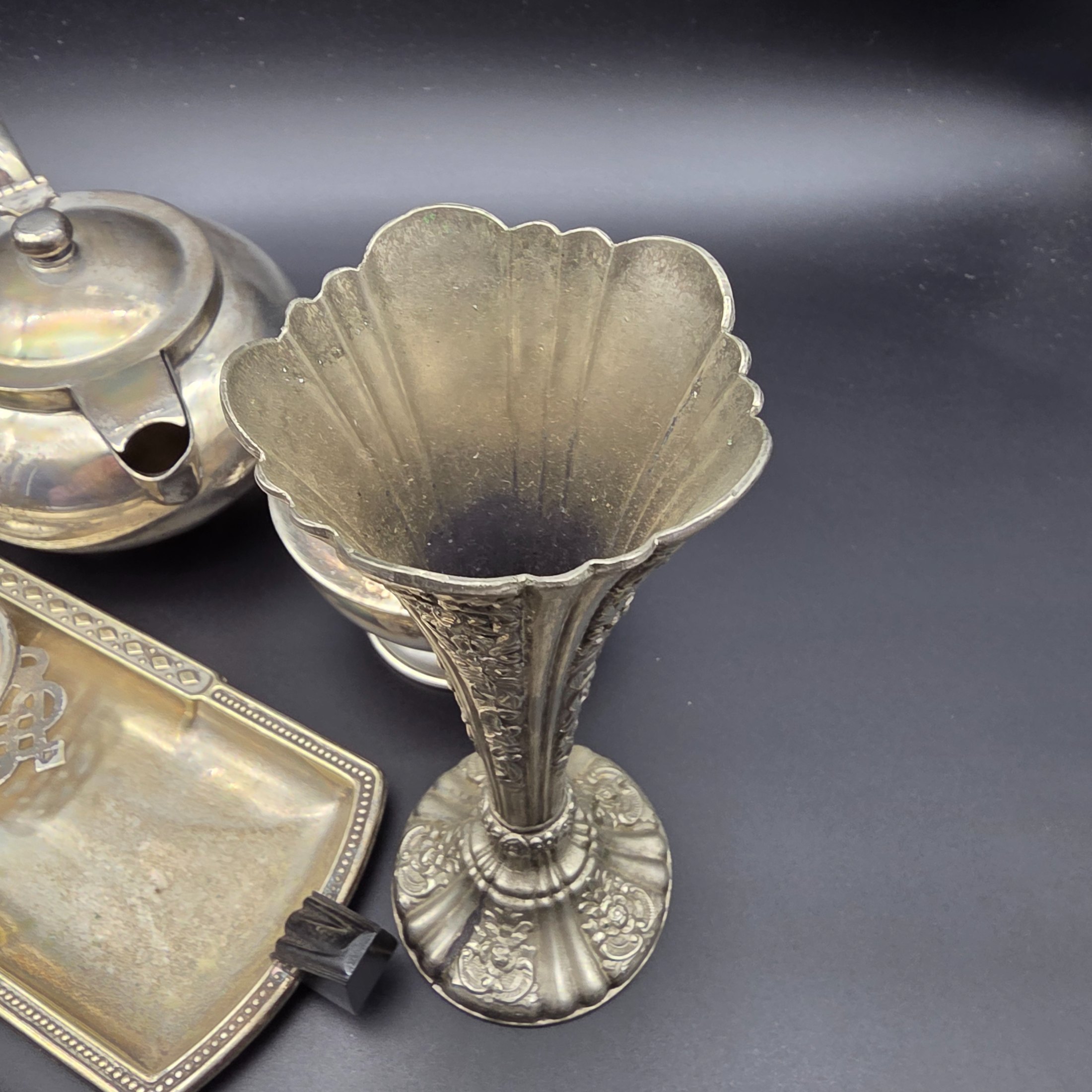 A varied collection of vintage F.B. Rogers silverplate items, including a compote, teapot, cream jug, sugar bowl, vase, goblet, and various trays, all showing signs of age and tarnishing. - View 3