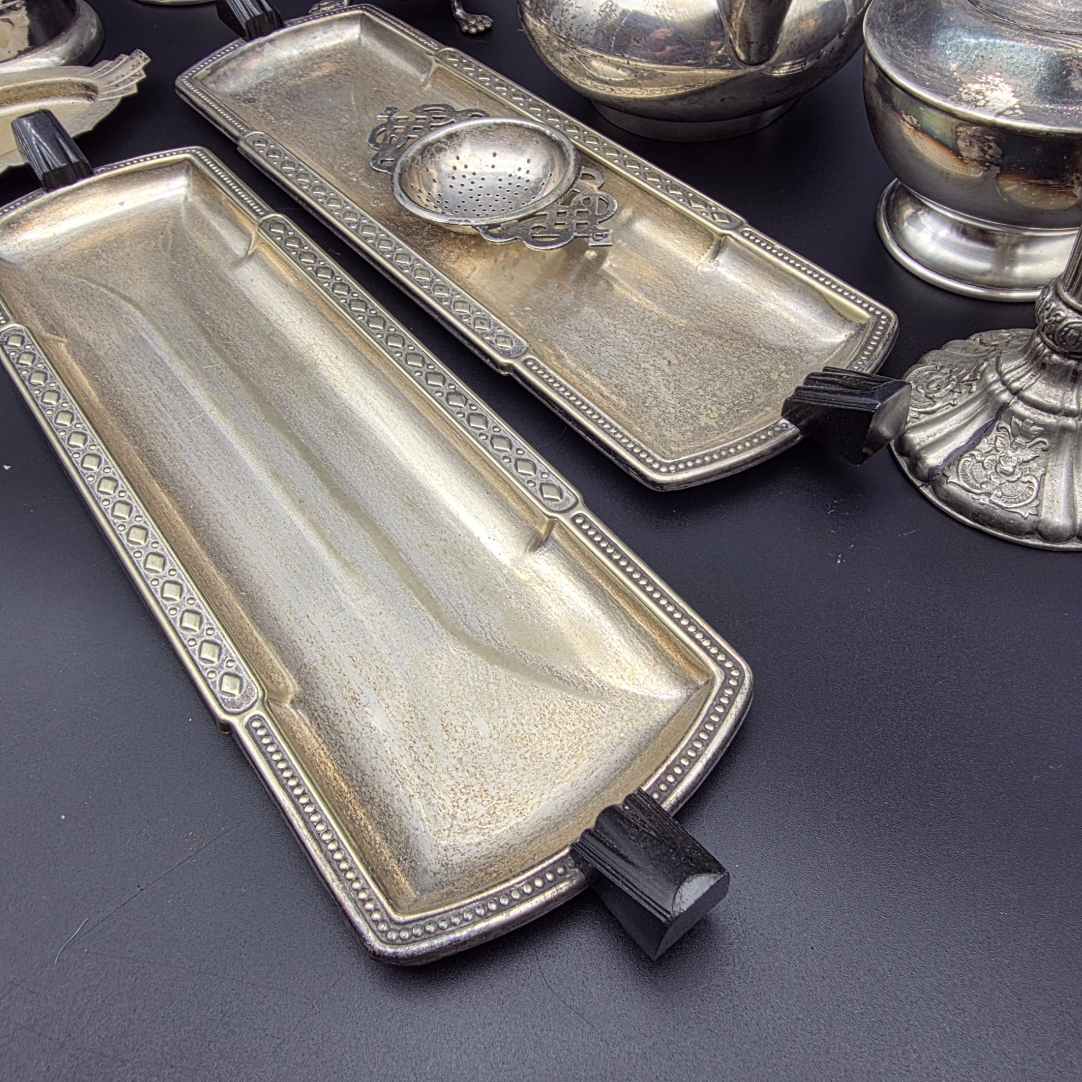A varied collection of vintage F.B. Rogers silverplate items, including a compote, teapot, cream jug, sugar bowl, vase, goblet, and various trays, all showing signs of age and tarnishing. - View 4