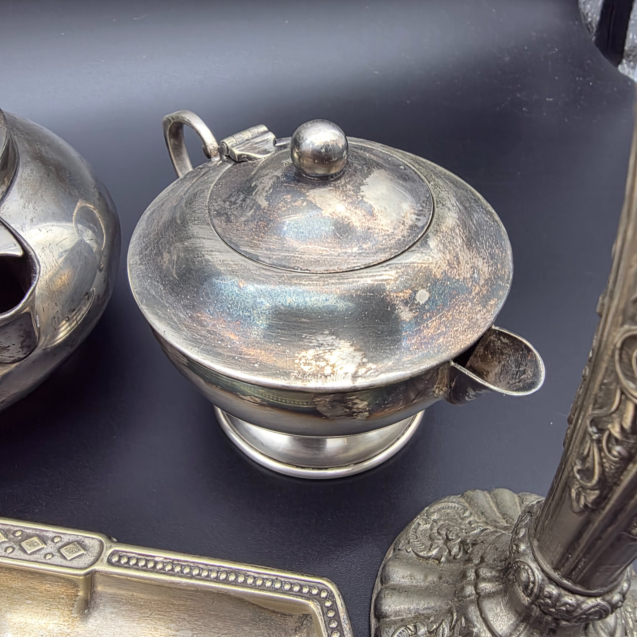 A varied collection of vintage F.B. Rogers silverplate items, including a compote, teapot, cream jug, sugar bowl, vase, goblet, and various trays, all showing signs of age and tarnishing. - View 5