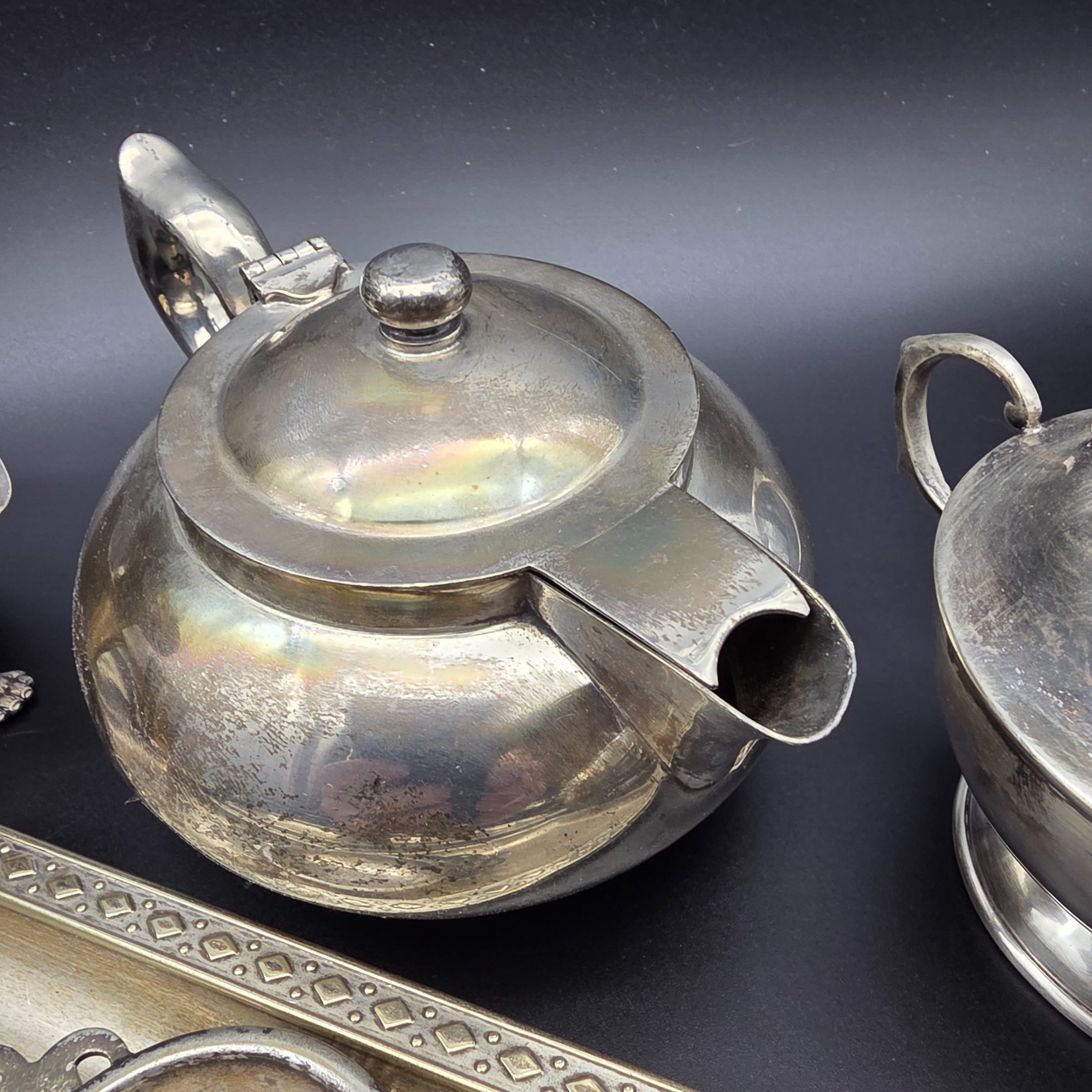 A varied collection of vintage F.B. Rogers silverplate items, including a compote, teapot, cream jug, sugar bowl, vase, goblet, and various trays, all showing signs of age and tarnishing. - View 6