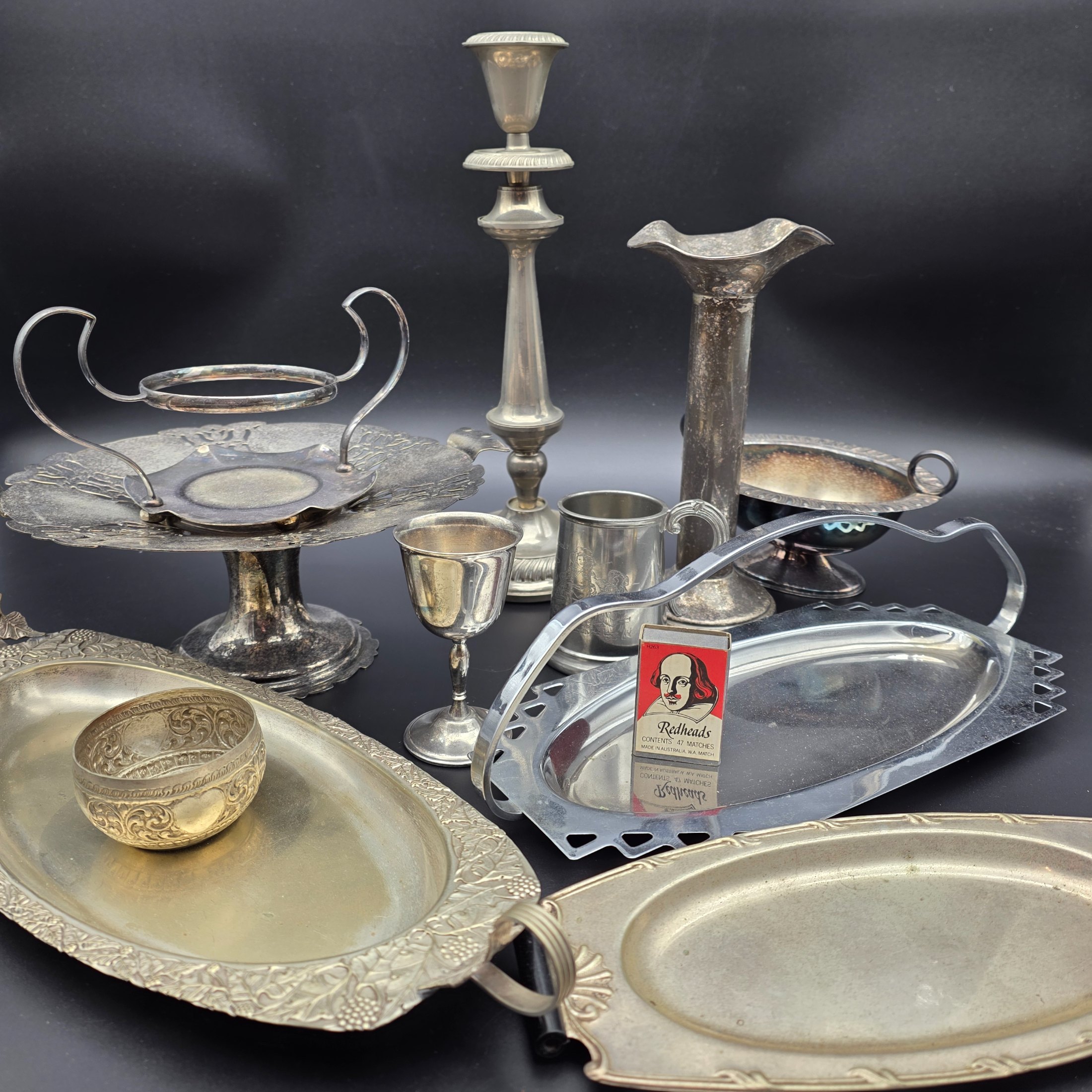 A comprehensive collection of vintage silver-plated homewares and decorative sundries, including various serving trays, a cake stand, candlesticks, a goblet, a tankard, and decorative bowls.