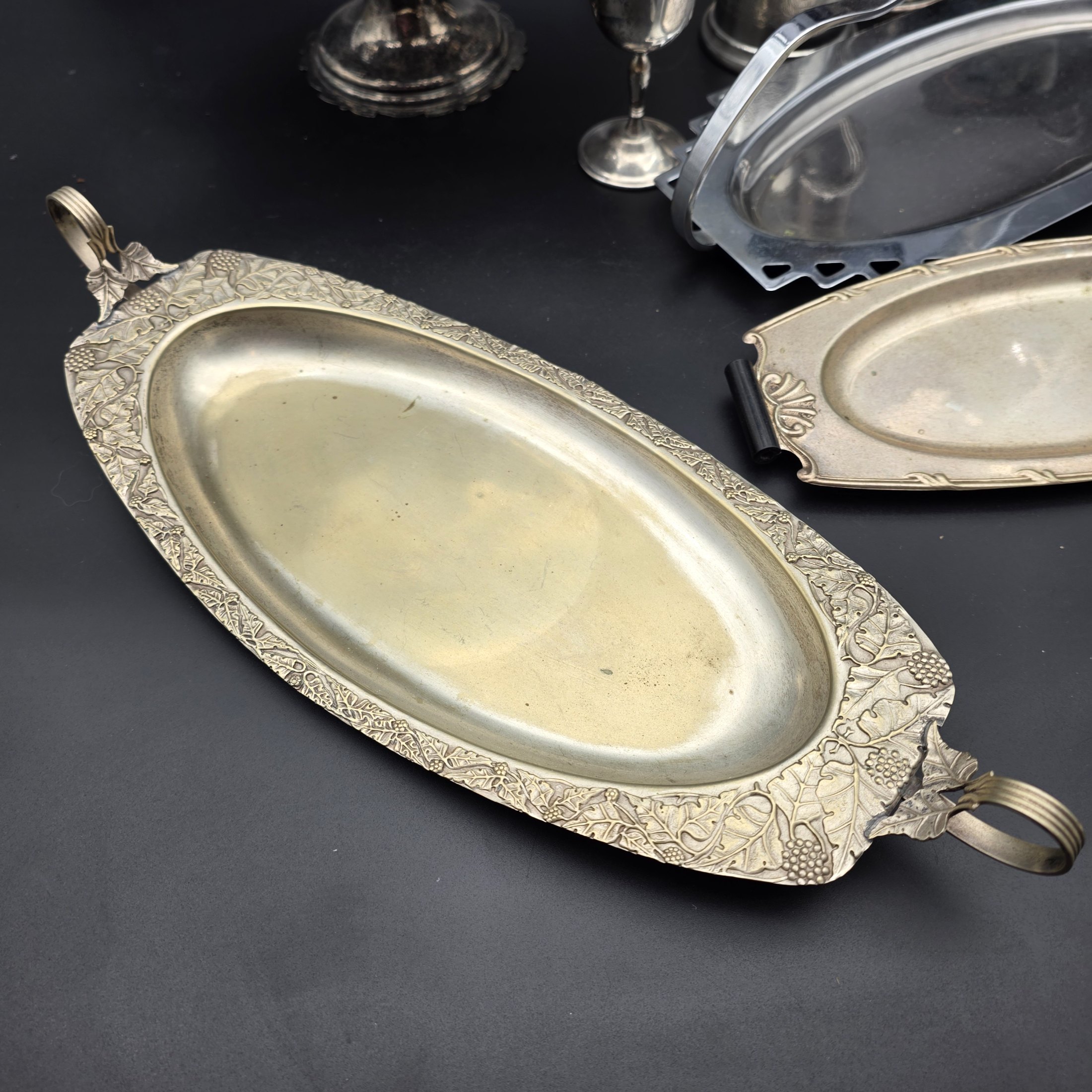 A comprehensive collection of vintage silver-plated homewares and decorative sundries, including various serving trays, a cake stand, candlesticks, a goblet, a tankard, and decorative bowls. - View 5