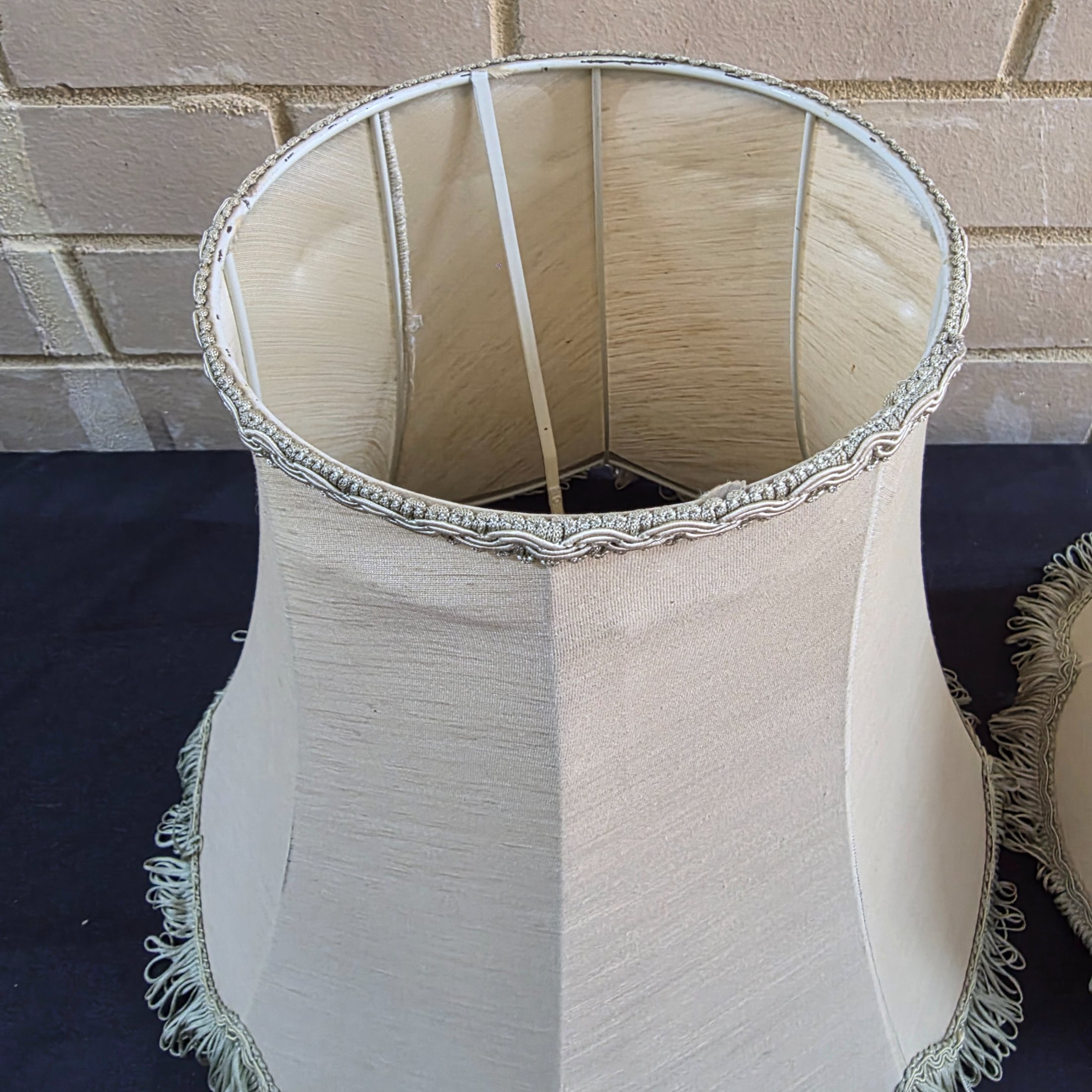 A pair of vintage bell-shaped lampshades, crafted from light fabric with ornate trim and fringe, suitable for traditional interior decor. - View 2