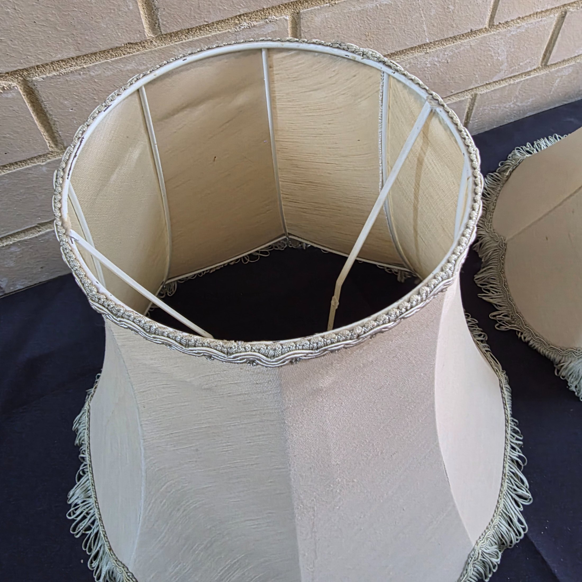 A pair of vintage bell-shaped lampshades, crafted from light fabric with ornate trim and fringe, suitable for traditional interior decor. - View 3