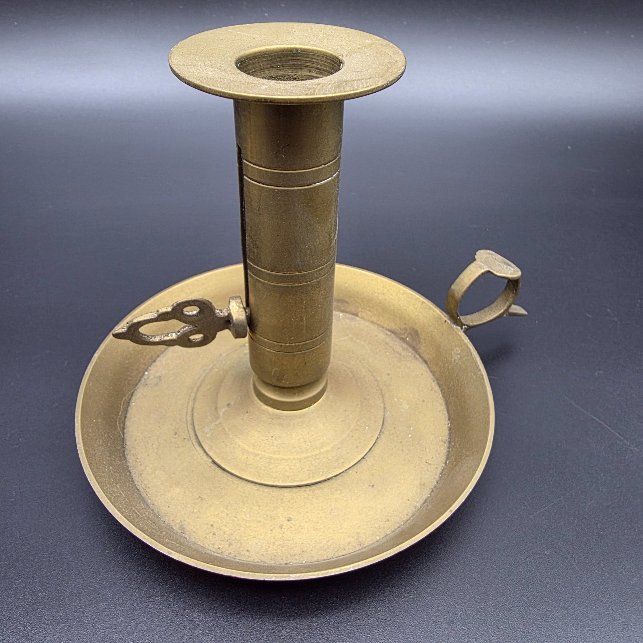A lot of vintage brass and copper candle accessories, including two candlesticks and a decorative taper holder with an attached snuffer, likely dating from the early to mid-20th century. - View 7