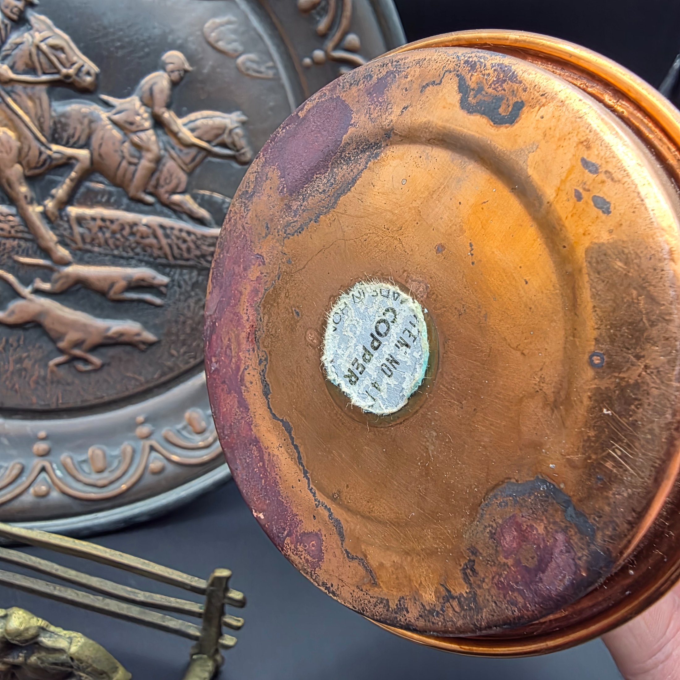 A curated collection of vintage metallic decorative sundries, primarily crafted from brass and copper, spanning mid to late 20th-century origins, including an embossed wall plate, a plant mister, letter holder, ashtrays, a vase, and a small dish. - View 3