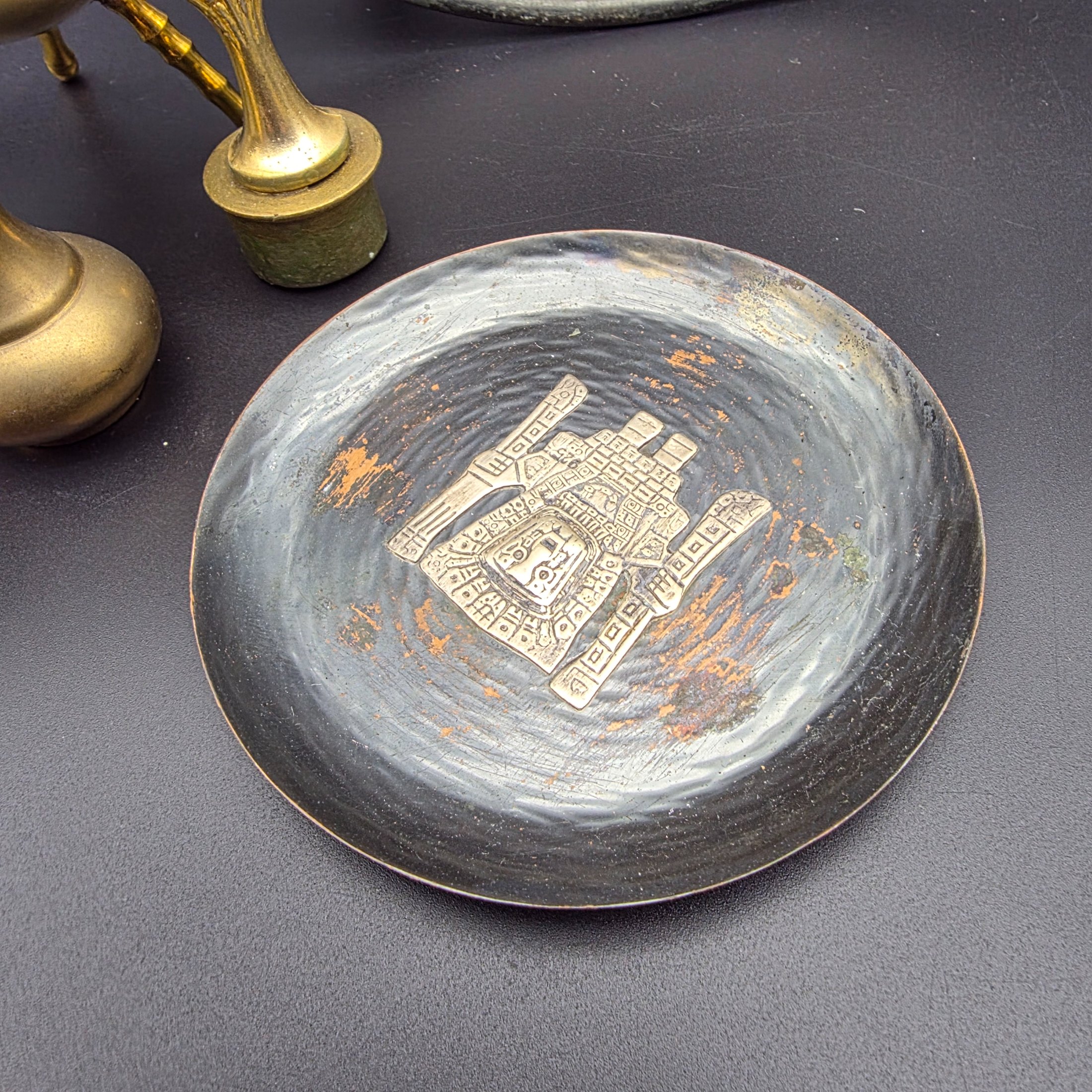 A curated collection of vintage metallic decorative sundries, primarily crafted from brass and copper, spanning mid to late 20th-century origins, including an embossed wall plate, a plant mister, letter holder, ashtrays, a vase, and a small dish. - View 6