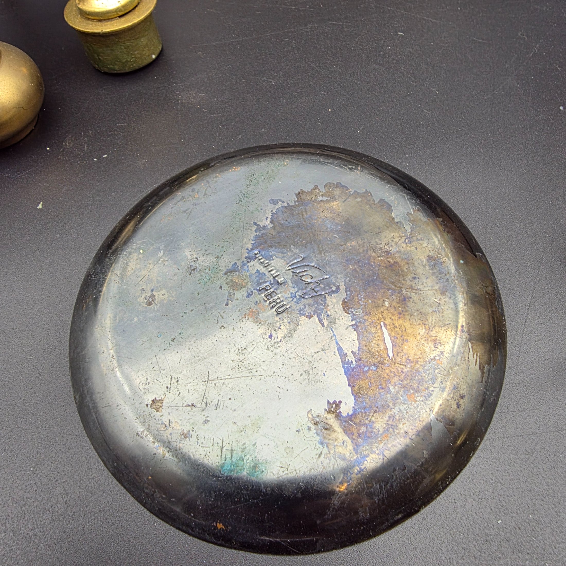 A curated collection of vintage metallic decorative sundries, primarily crafted from brass and copper, spanning mid to late 20th-century origins, including an embossed wall plate, a plant mister, letter holder, ashtrays, a vase, and a small dish. - View 7