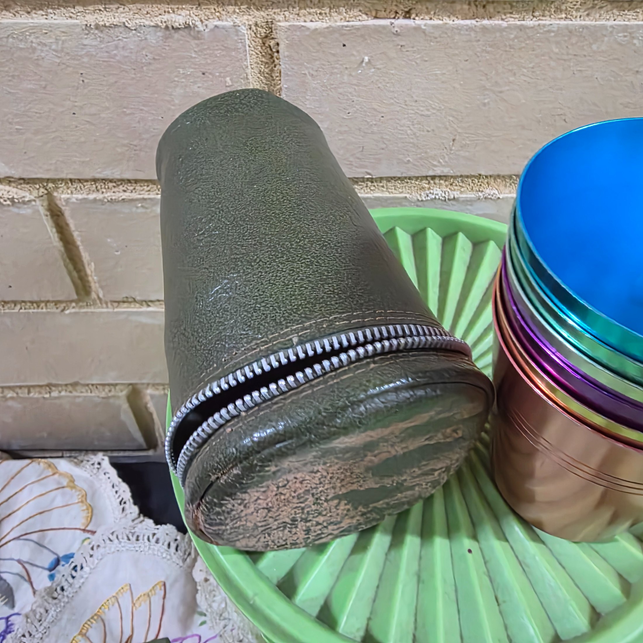 A diverse collection of vintage homewares and kitchen items including cast iron pans, a hand mixer, Tupperware, ceramic crocks, aluminium cups, and various other utensils and decorative pieces. - View 3