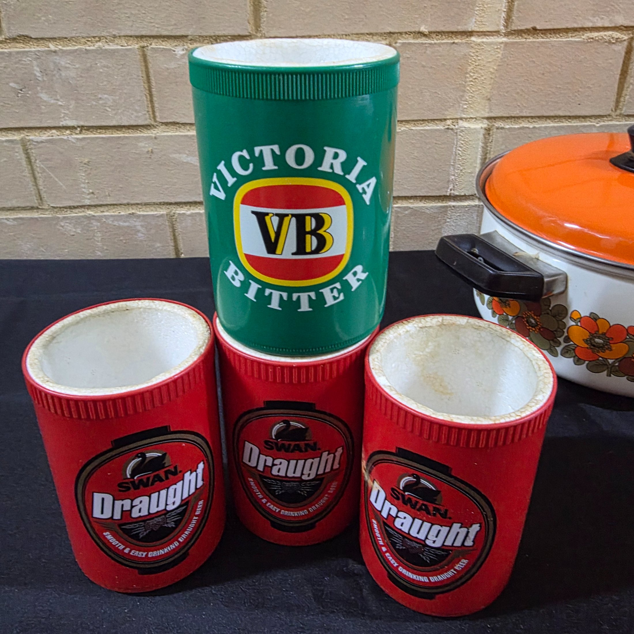 A varied collection of vintage kitchenware and homewares, showcasing mid-century design and practical items, including enamel pots, ceramic and stoneware pieces, and Australian beer coolers. - View 2