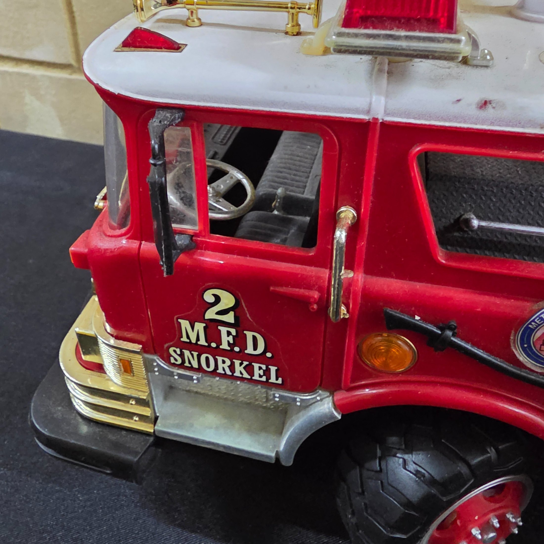 A vintage New Bright remote control toy fire engine, dating from around 1990, constructed from plastic and metal components. - View 7