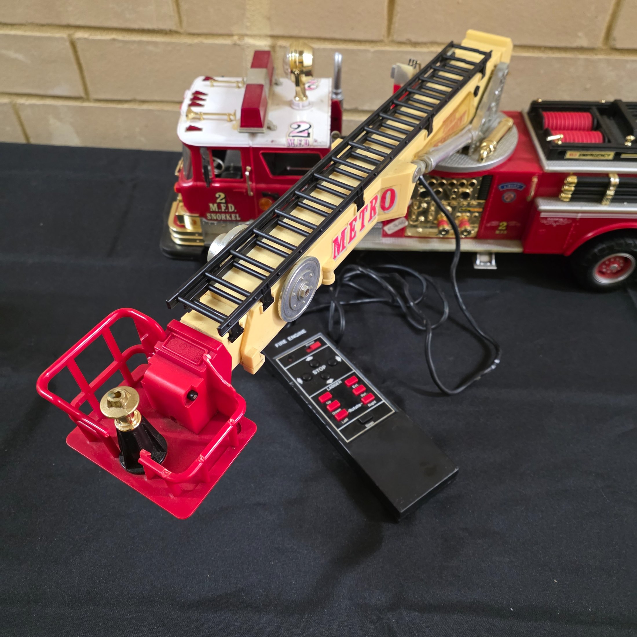 A vintage New Bright remote control toy fire engine, dating from around 1990, constructed from plastic and metal components. - View 8