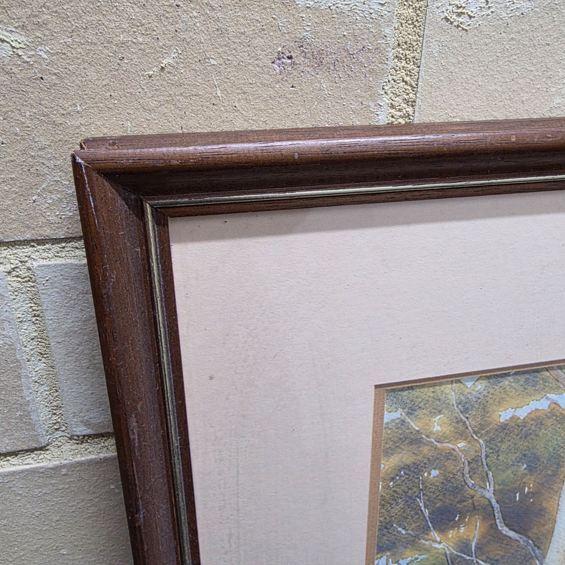 A framed original watercolour painting depicting a tranquil Australian bush scene with a dirt road winding through tall eucalypt trees, signed 'N. A. H.' and dated 1984. - View 3