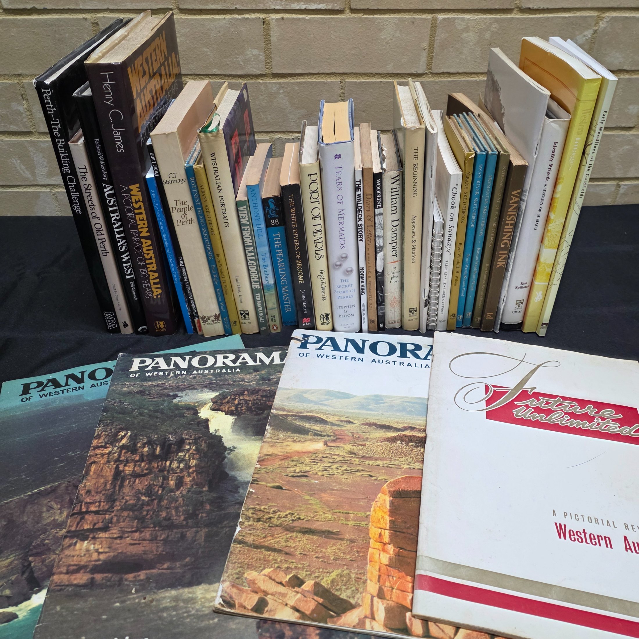 A substantial collection of books and magazines detailing the history, culture, and natural beauty of Western Australia, including specific regional studies and general overviews.