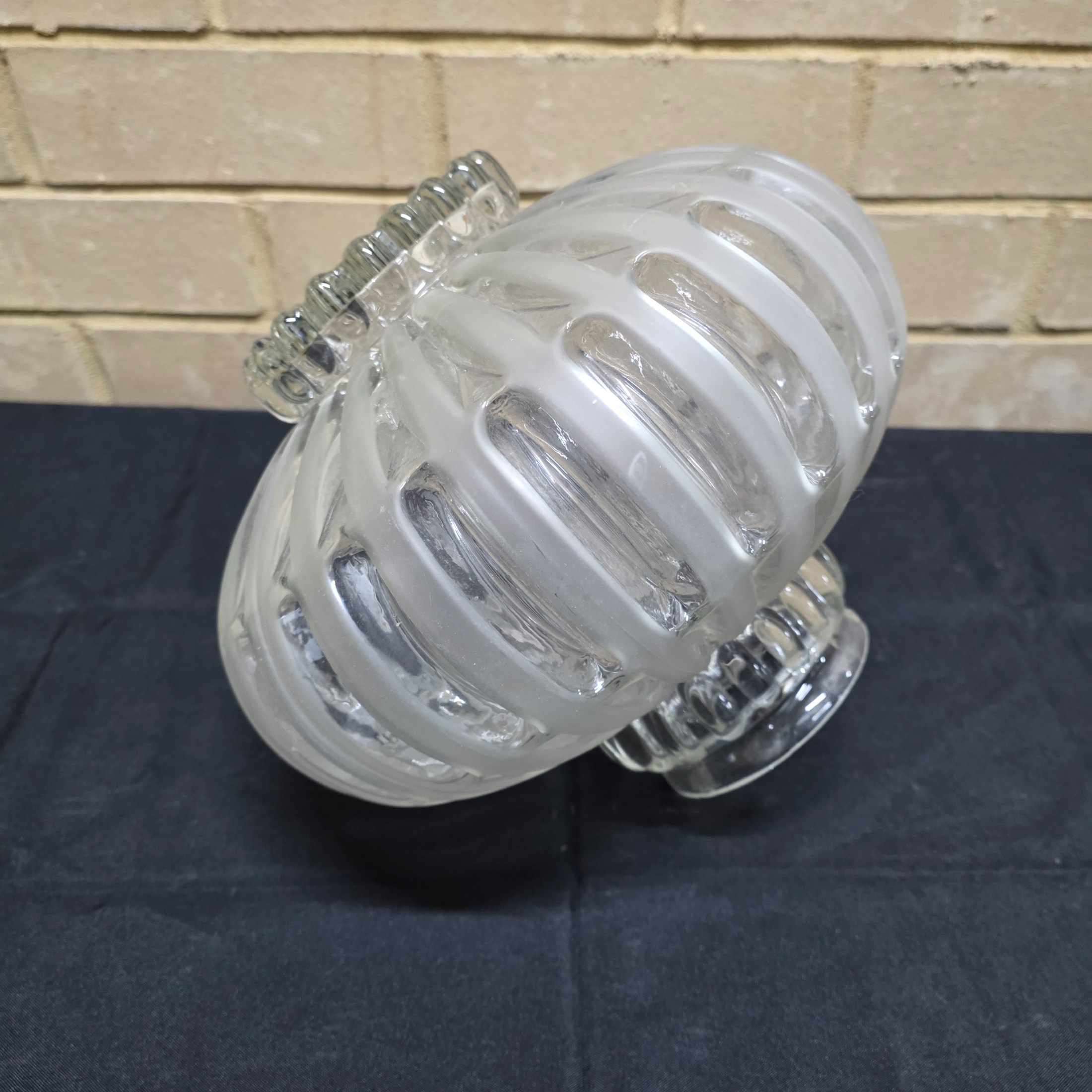 A vintage frosted glass light shade with a distinctive ribbed texture, likely dating from the mid-20th century.