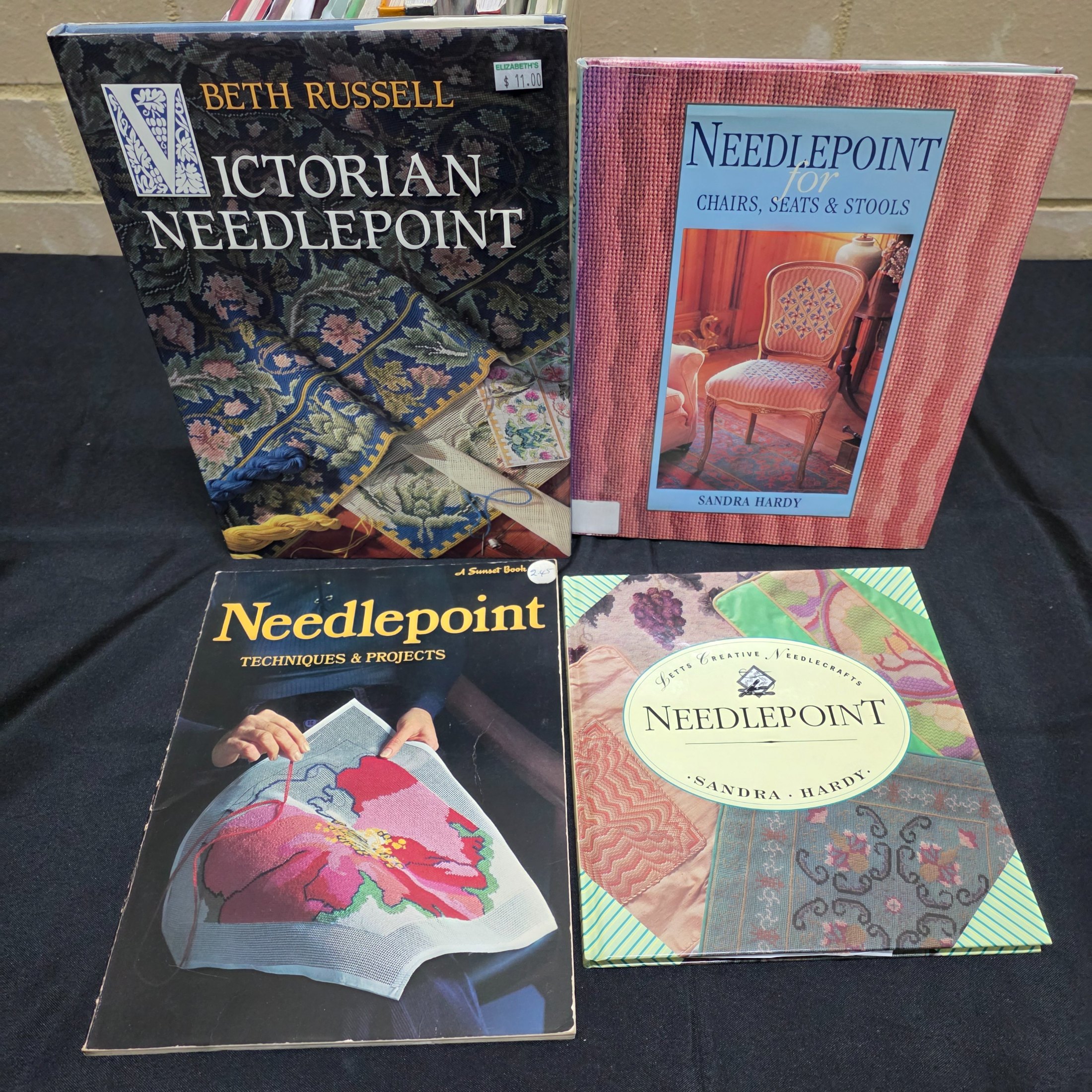 A collection of approximately 18 reference books focusing on needlecrafts and historical design, including titles on cross-stitch, needlepoint, tapestry, and Biedermeier art. - View 3
