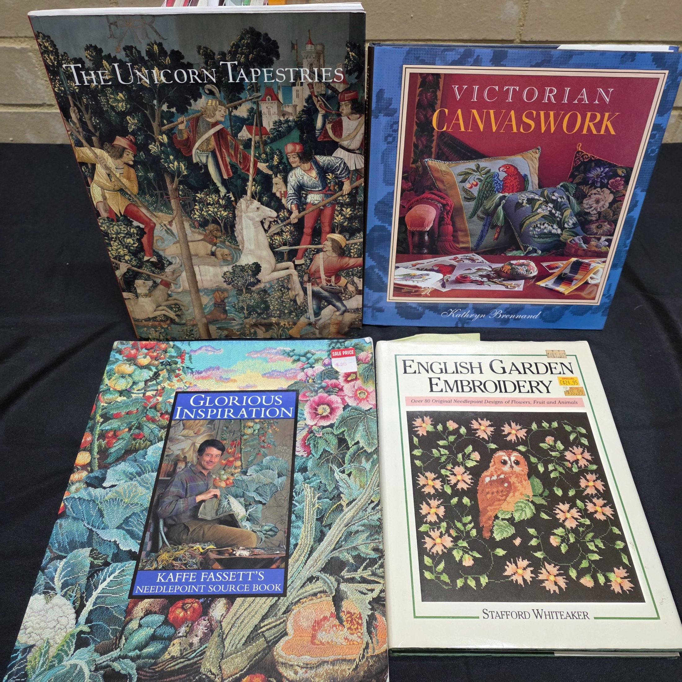 A collection of approximately 18 reference books focusing on needlecrafts and historical design, including titles on cross-stitch, needlepoint, tapestry, and Biedermeier art. - View 4
