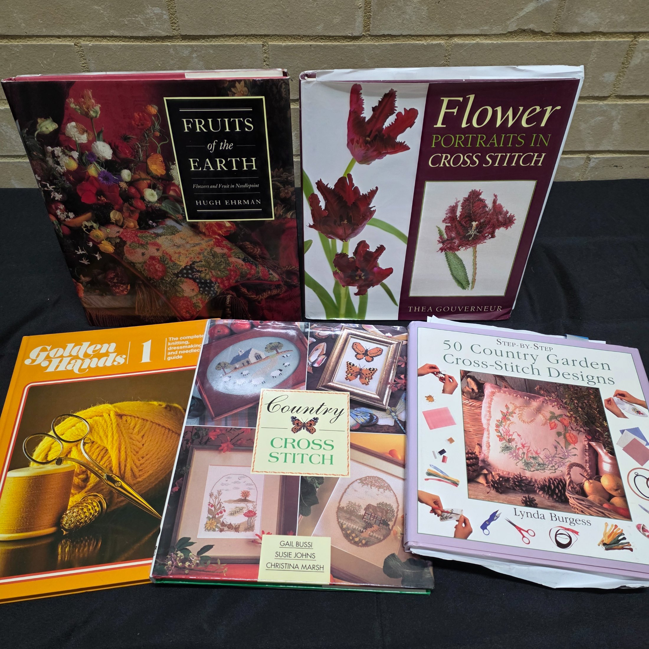 A collection of approximately 18 reference books focusing on needlecrafts and historical design, including titles on cross-stitch, needlepoint, tapestry, and Biedermeier art. - View 5