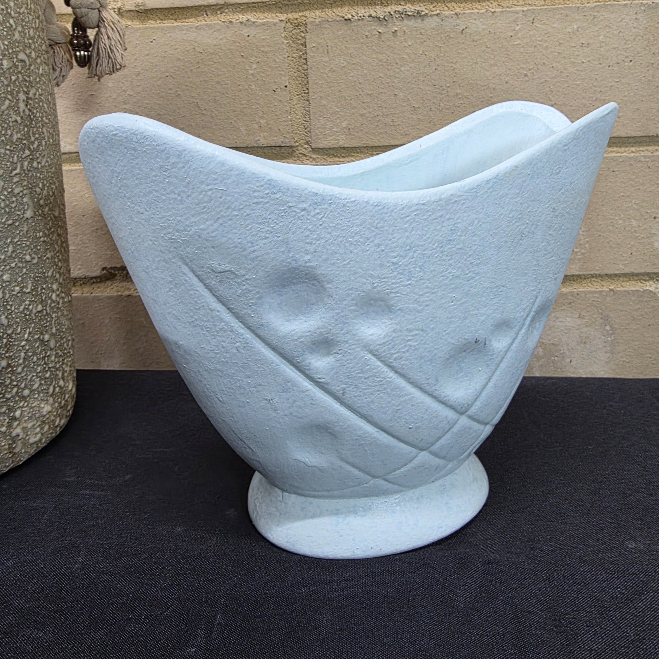 A collection of vintage Australian ceramic sundries, including a textured Micasa vase with rope, a pink Raynham shell-shaped vase, a light blue Surrey vase, a black and white condiment holder, and a light green shell-like decorative piece. - View 3