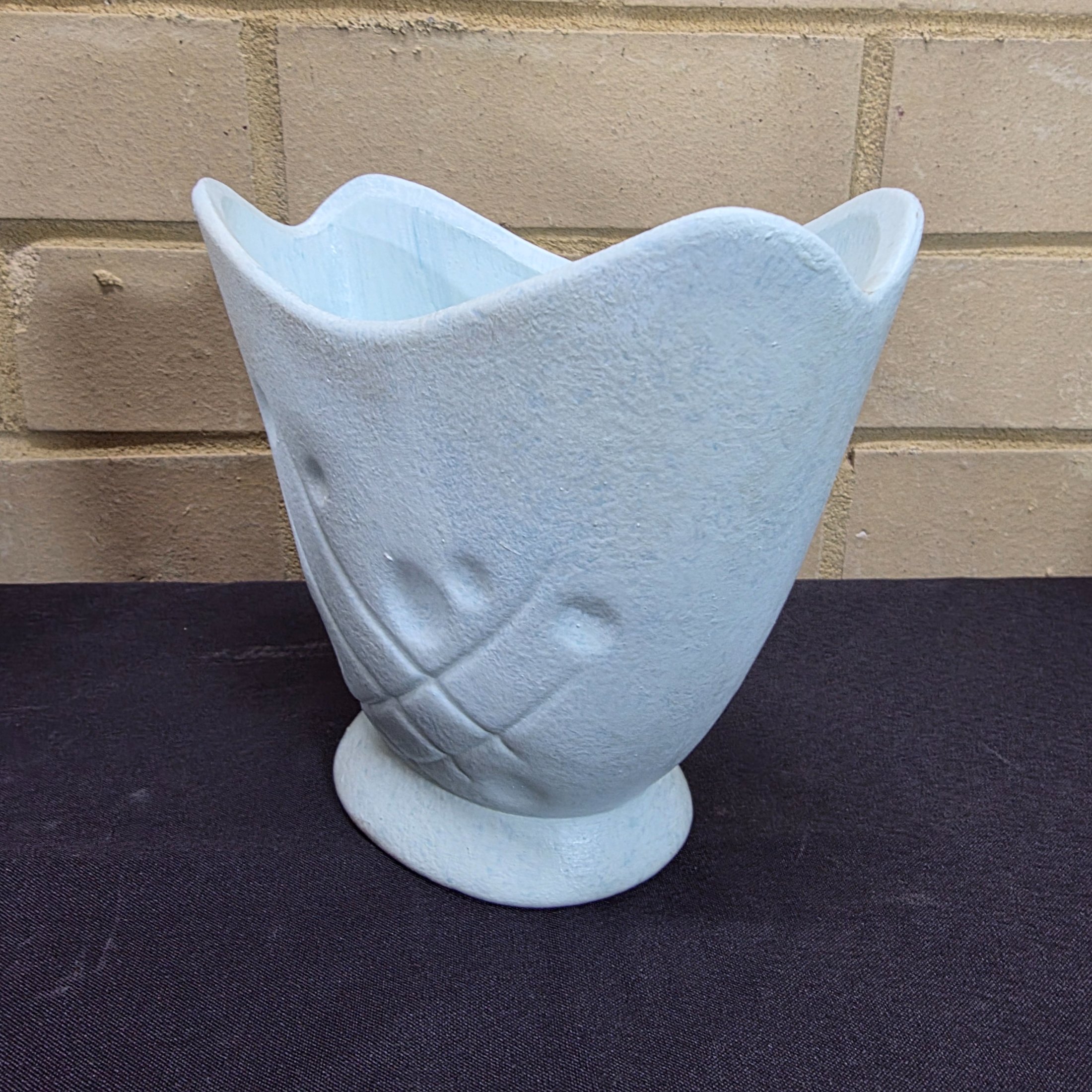 A collection of vintage Australian ceramic sundries, including a textured Micasa vase with rope, a pink Raynham shell-shaped vase, a light blue Surrey vase, a black and white condiment holder, and a light green shell-like decorative piece. - View 4