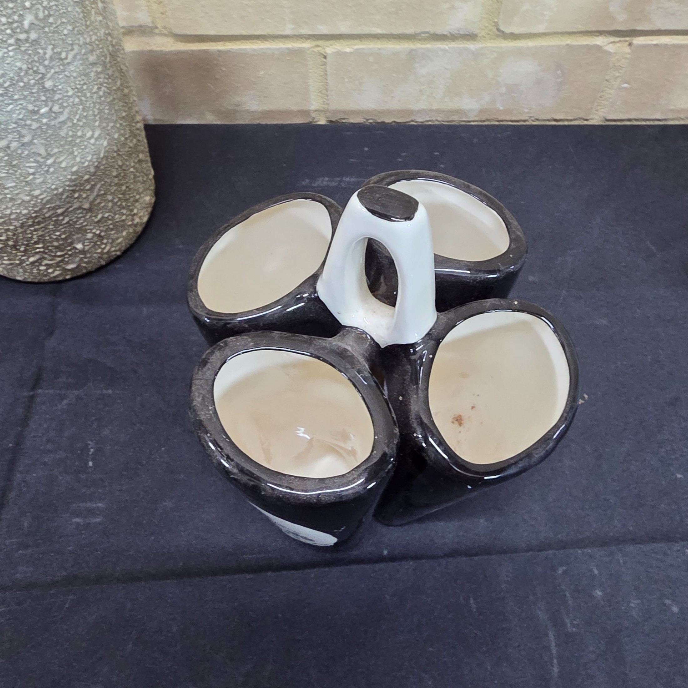 A collection of vintage Australian ceramic sundries, including a textured Micasa vase with rope, a pink Raynham shell-shaped vase, a light blue Surrey vase, a black and white condiment holder, and a light green shell-like decorative piece. - View 7