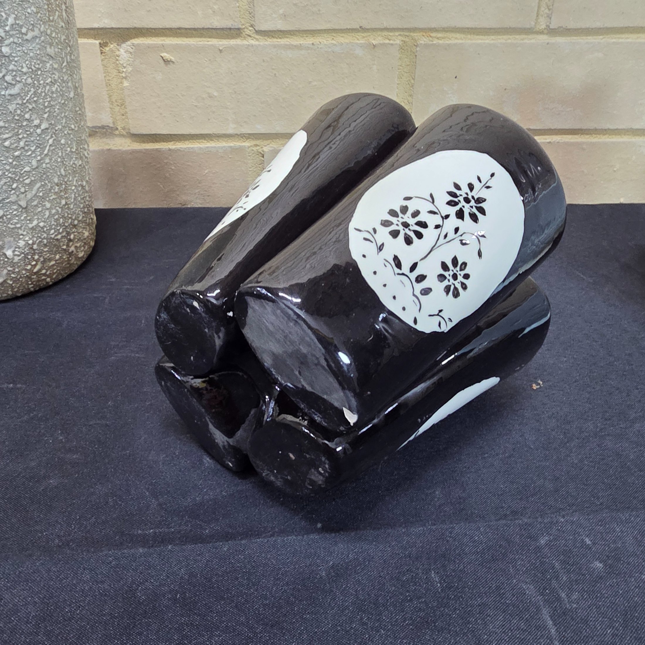 A collection of vintage Australian ceramic sundries, including a textured Micasa vase with rope, a pink Raynham shell-shaped vase, a light blue Surrey vase, a black and white condiment holder, and a light green shell-like decorative piece. - View 8