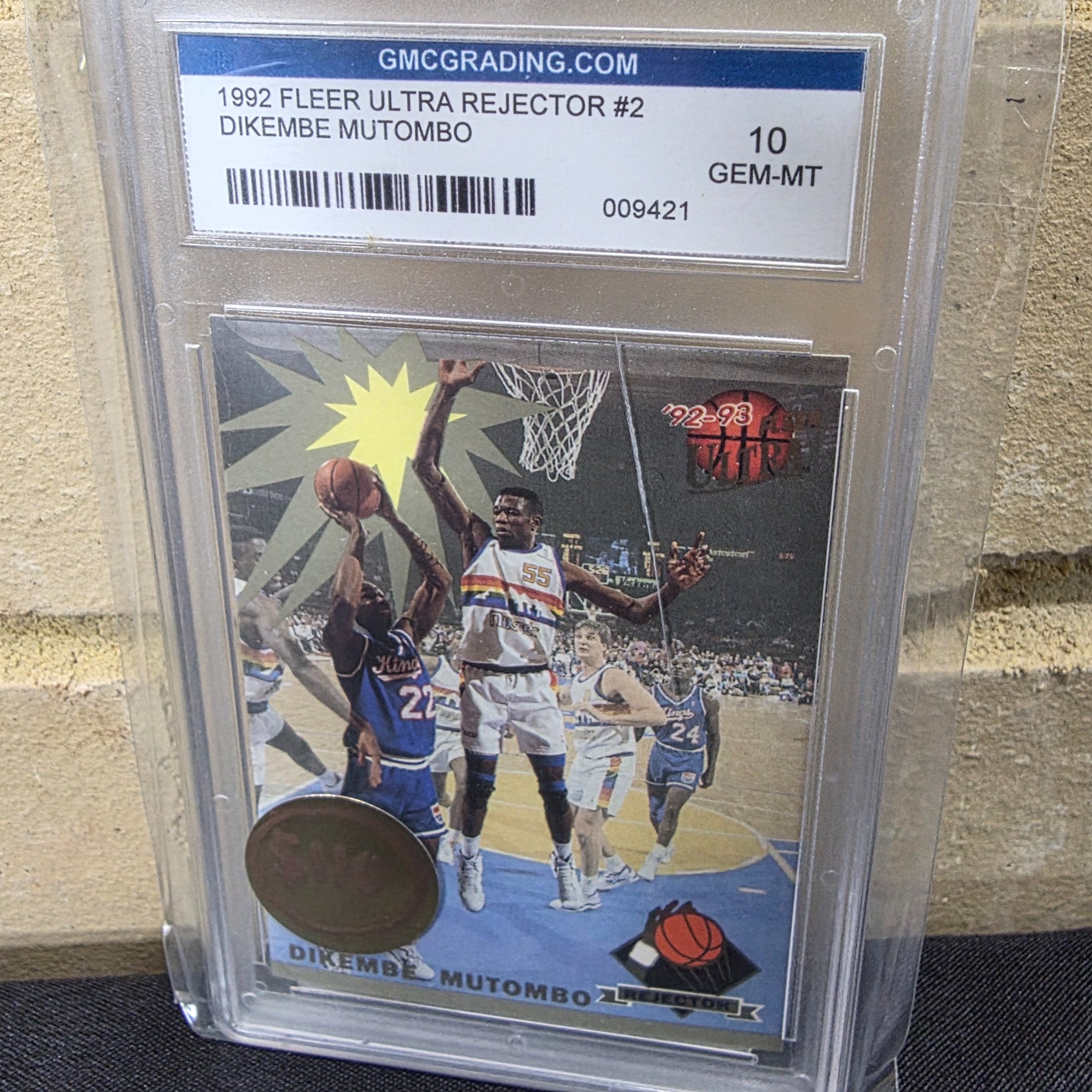 A professionally graded 1992 Fleer Ultra Rejector #2 basketball trading card featuring Dikembe Mutombo, achieving a GEM-MT 10 grade from GMC Grading.