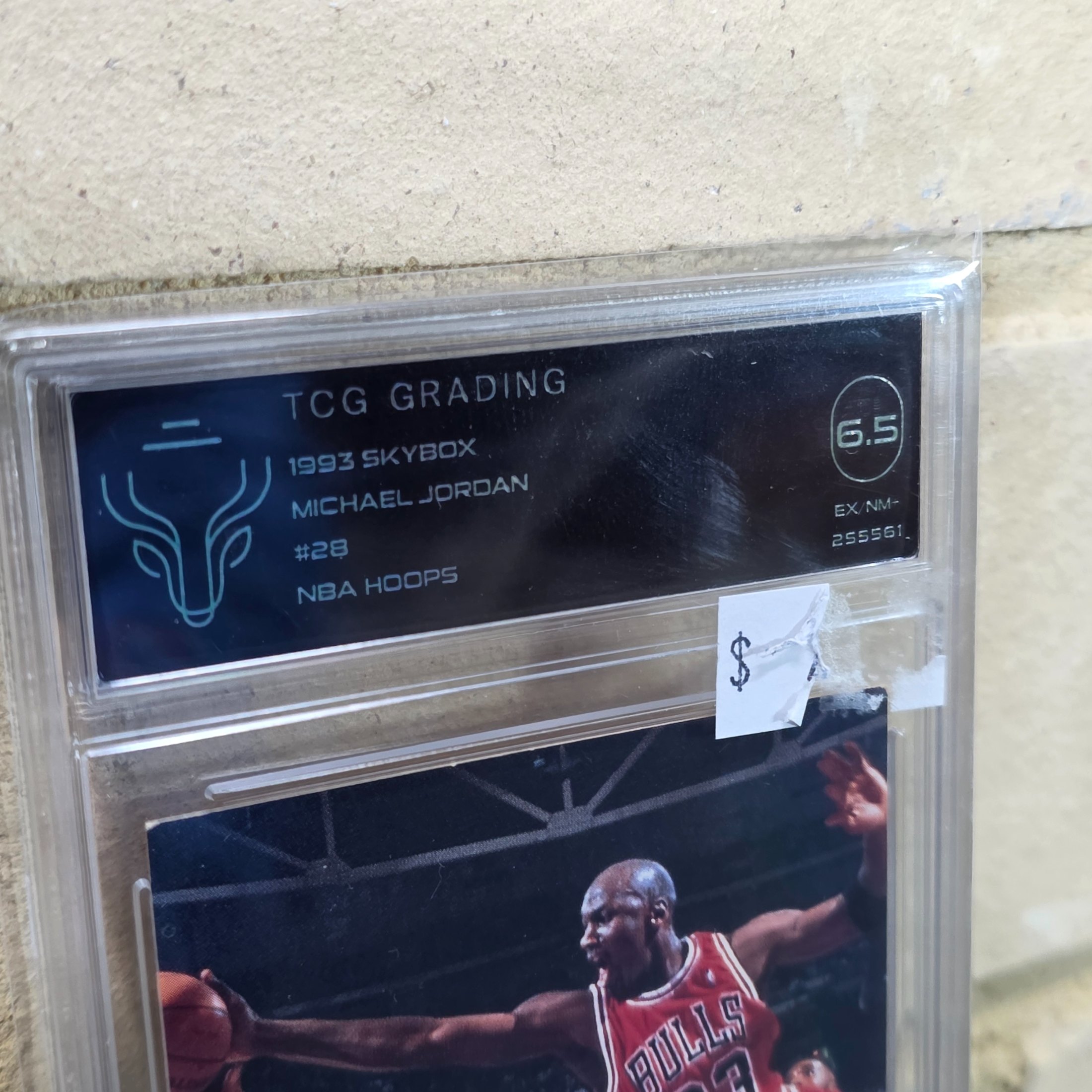 A 1993 Skybox NBA Hoops Michael Jordan #28 basketball trading card, professionally graded 6.5 (EX-NM+) by TCG Grading, featuring the iconic Chicago Bulls player. - View 2