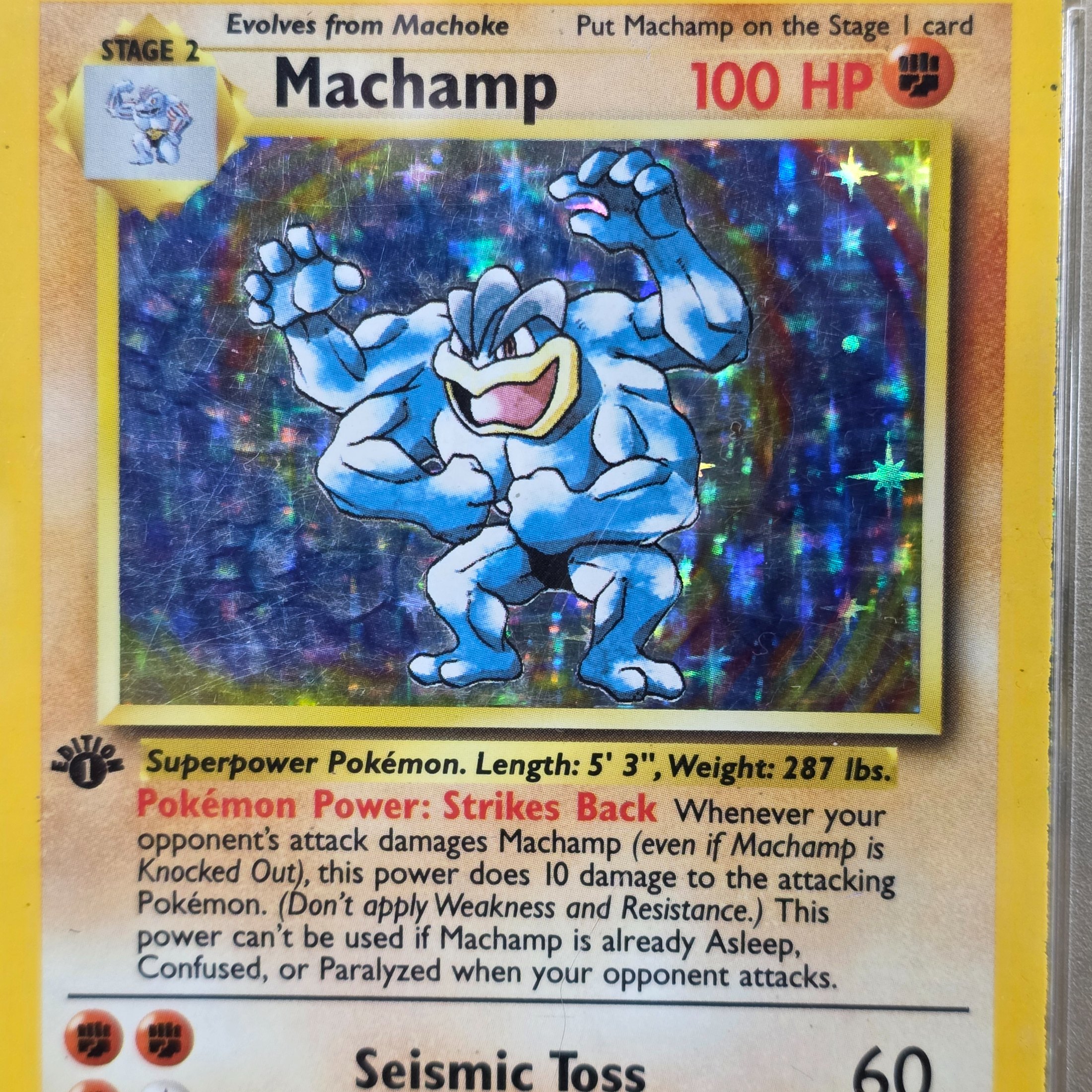 A 1999 Pokémon Game Machamp-Holo 1st Edition trading card, professionally graded PSA GOOD 2, displayed in a protective slab. - View 3