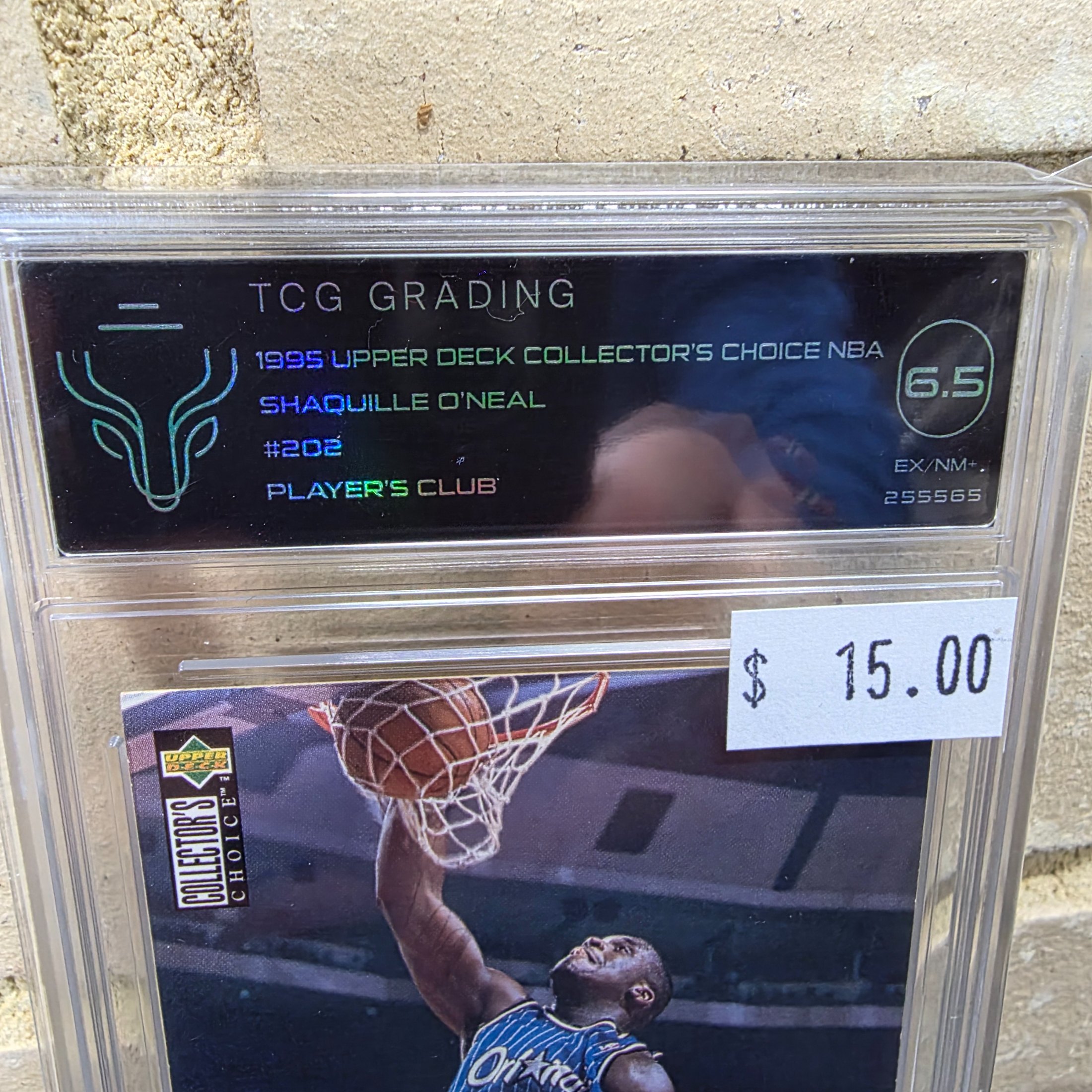 A 1995 Upper Deck Collector's Choice NBA Shaquille O'Neal #202 Player's Club basketball card, professionally graded 6.5 EX/NM+ by TCG Grading, encased in a protective slab. - View 2