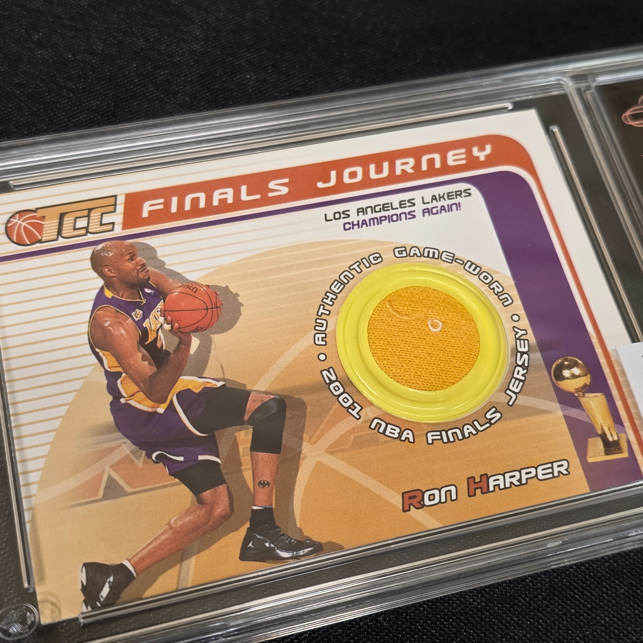 A 2001 Topps NBA Finals Journey graded trading card featuring Ron Harper with an authentic game-worn jersey swatch, encapsulated in a TCG Grading slab. - View 2