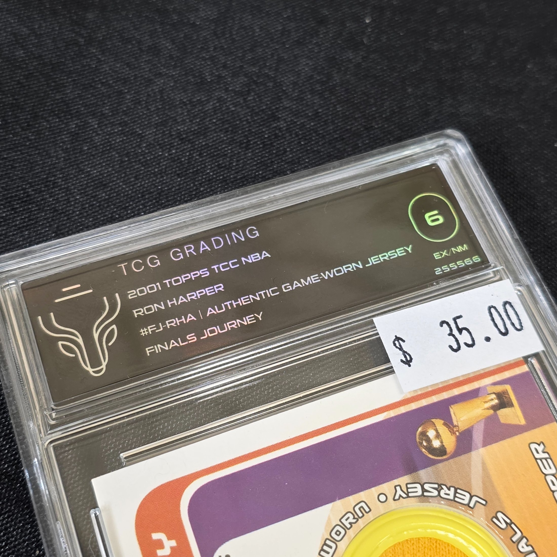 A 2001 Topps NBA Finals Journey graded trading card featuring Ron Harper with an authentic game-worn jersey swatch, encapsulated in a TCG Grading slab. - View 3
