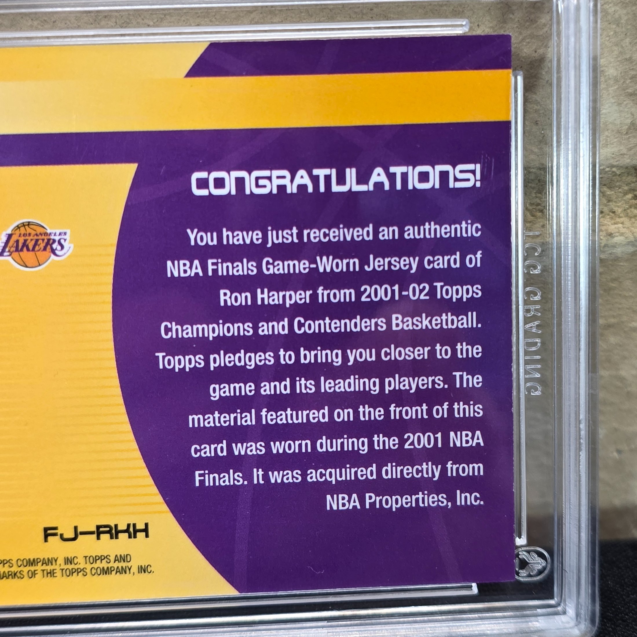 A 2001 Topps NBA Finals Journey graded trading card featuring Ron Harper with an authentic game-worn jersey swatch, encapsulated in a TCG Grading slab. - View 6