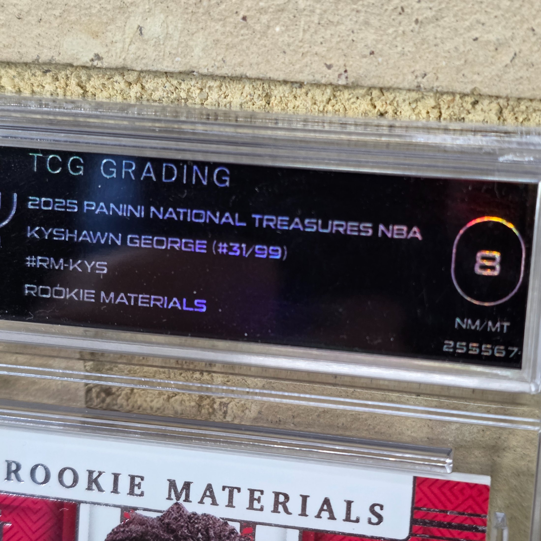 A 2025 Panini National Treasures NBA Kyshawn George Rookie Materials trading card, graded 8 NM/MT by TCG Grading, featuring a jersey patch. - View 4