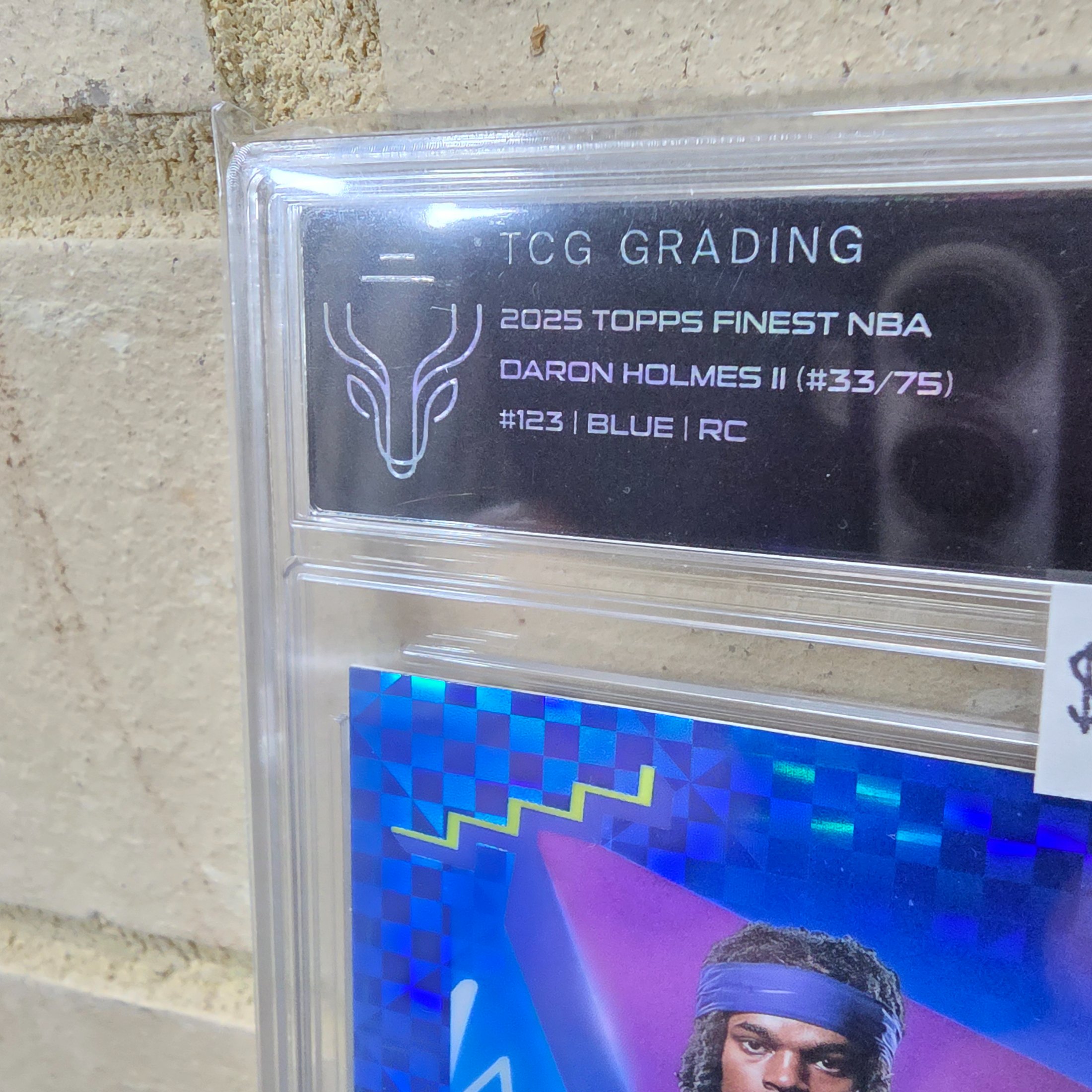 A 2025 Topps Finest NBA Daron Holmes II Blue parallel Rookie Card, graded NM-MT 8 by TCG Grading, individually numbered 33 out of 75. - View 2