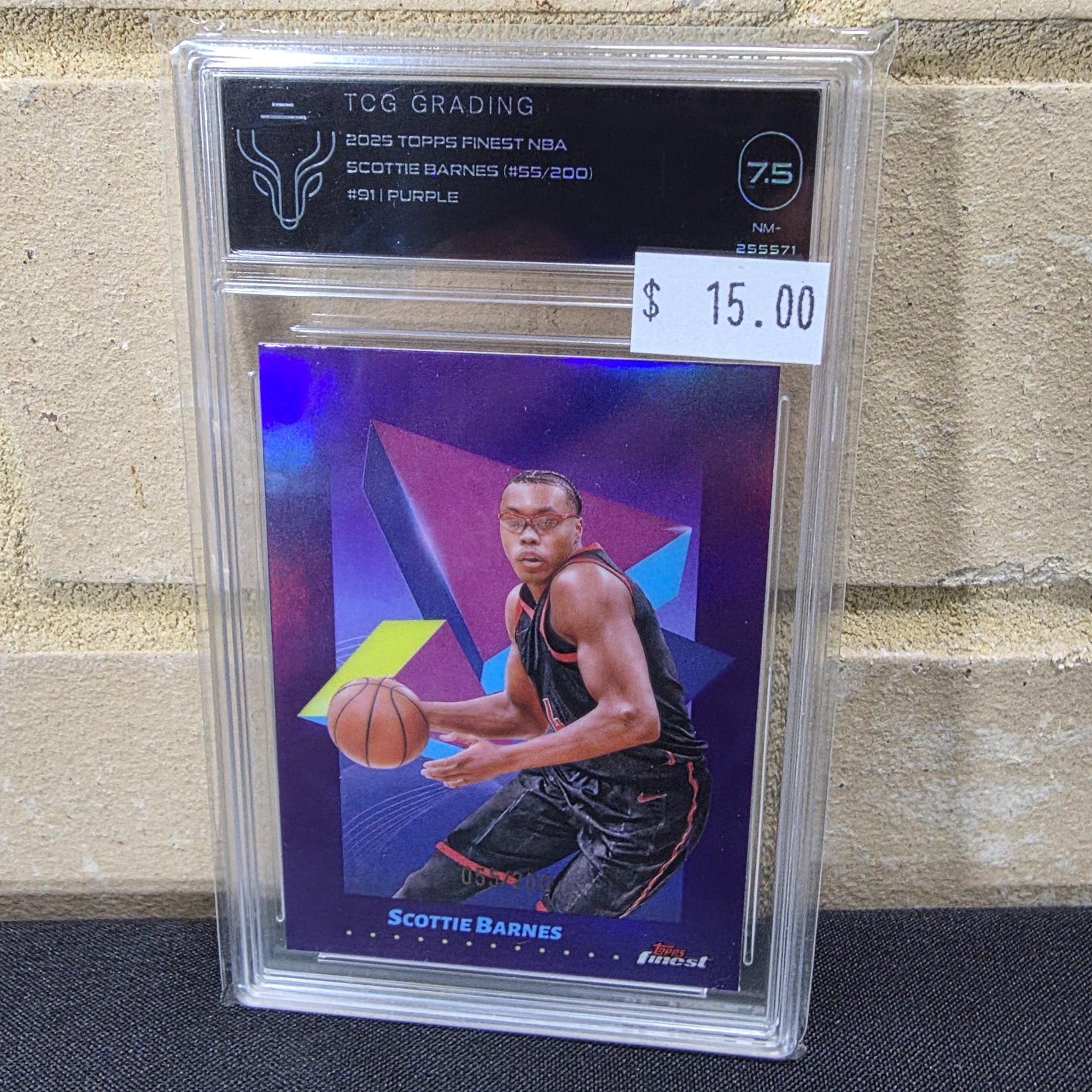 A graded 2025 Topps Finest NBA Scottie Barnes #911 Purple parallel basketball trading card, numbered 55/200, encapsulated in a TCG Grading slab with a grade of 7.5 NM-.