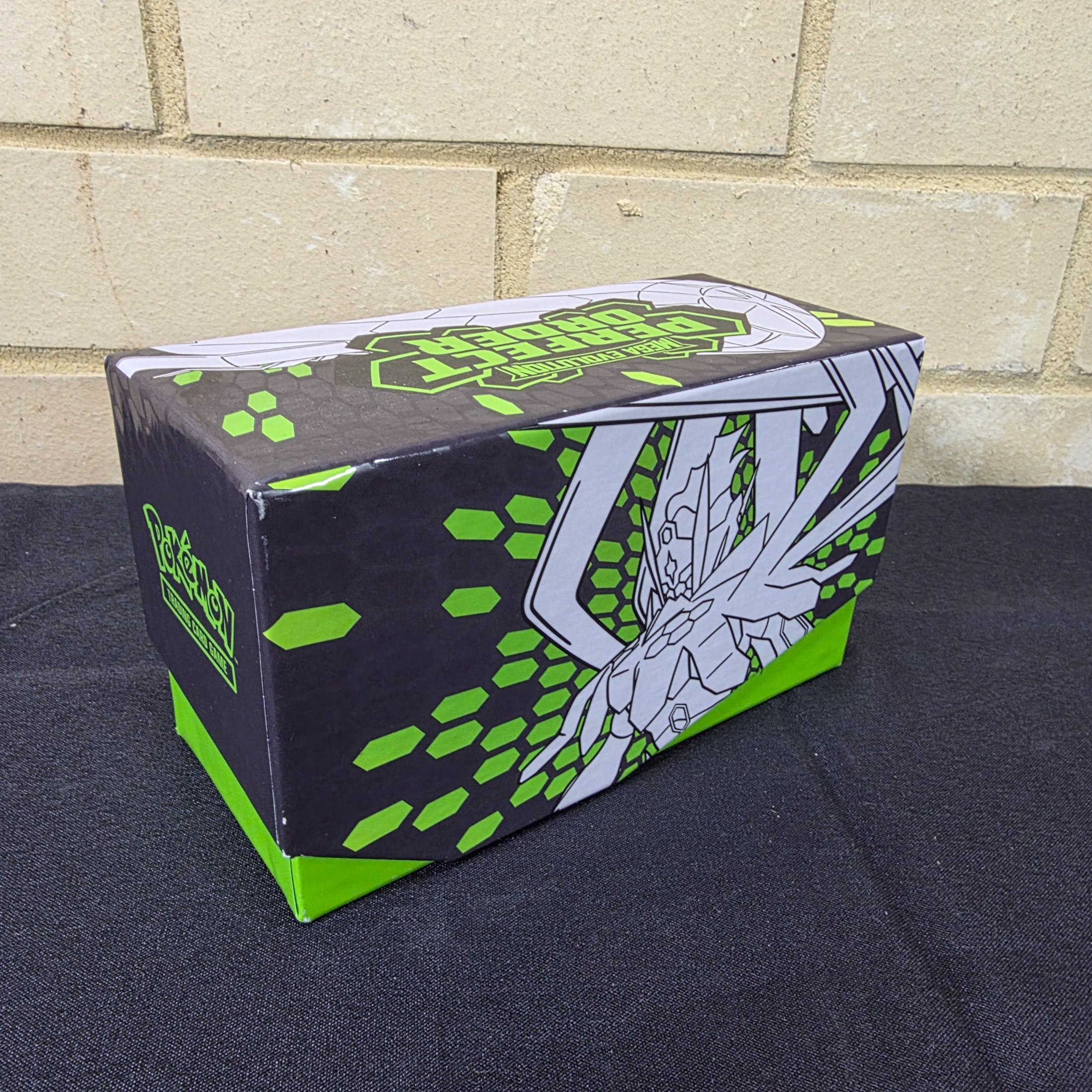 A green and black Pokémon Trading Card Game 'Perfect Order' storage box filled with assorted bulk cards. - View 2