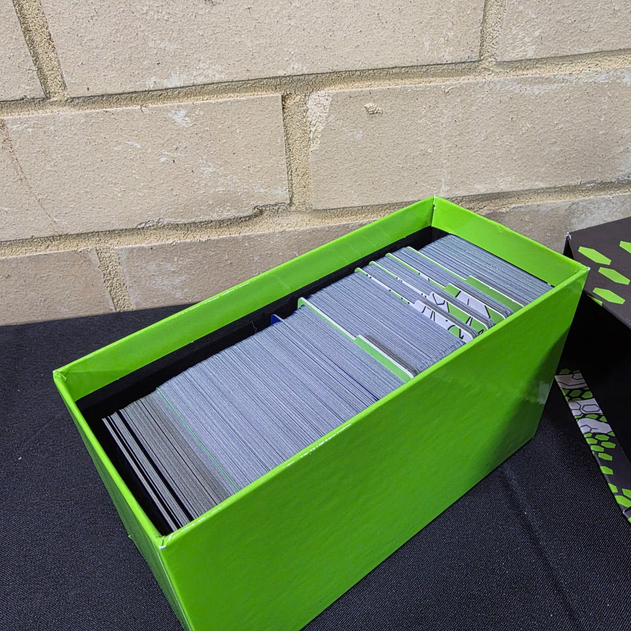 A green and black Pokémon Trading Card Game 'Perfect Order' storage box filled with assorted bulk cards. - View 3
